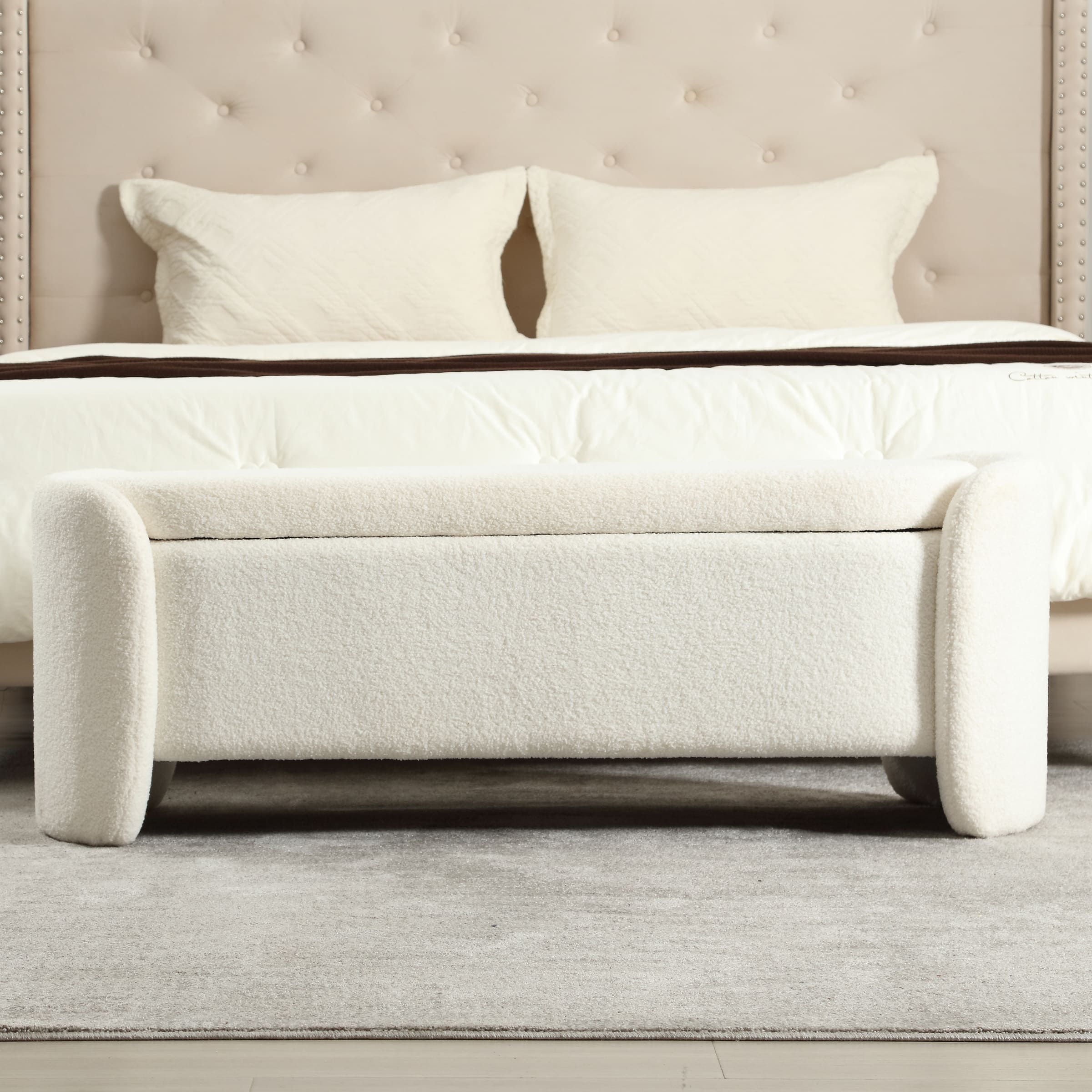 White Sherpa storage bench at foot of bed with lid closed