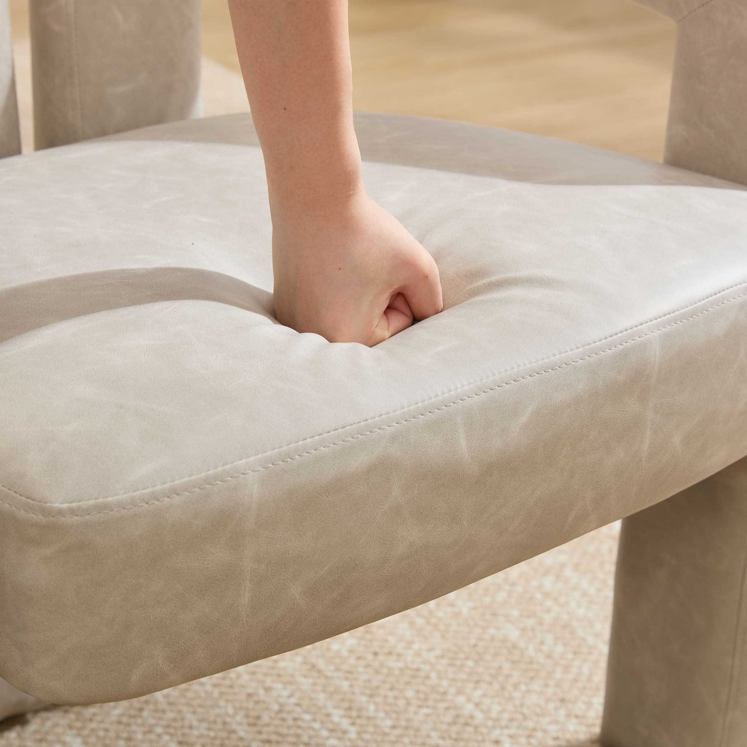 Close-up of chair seat being pressed
