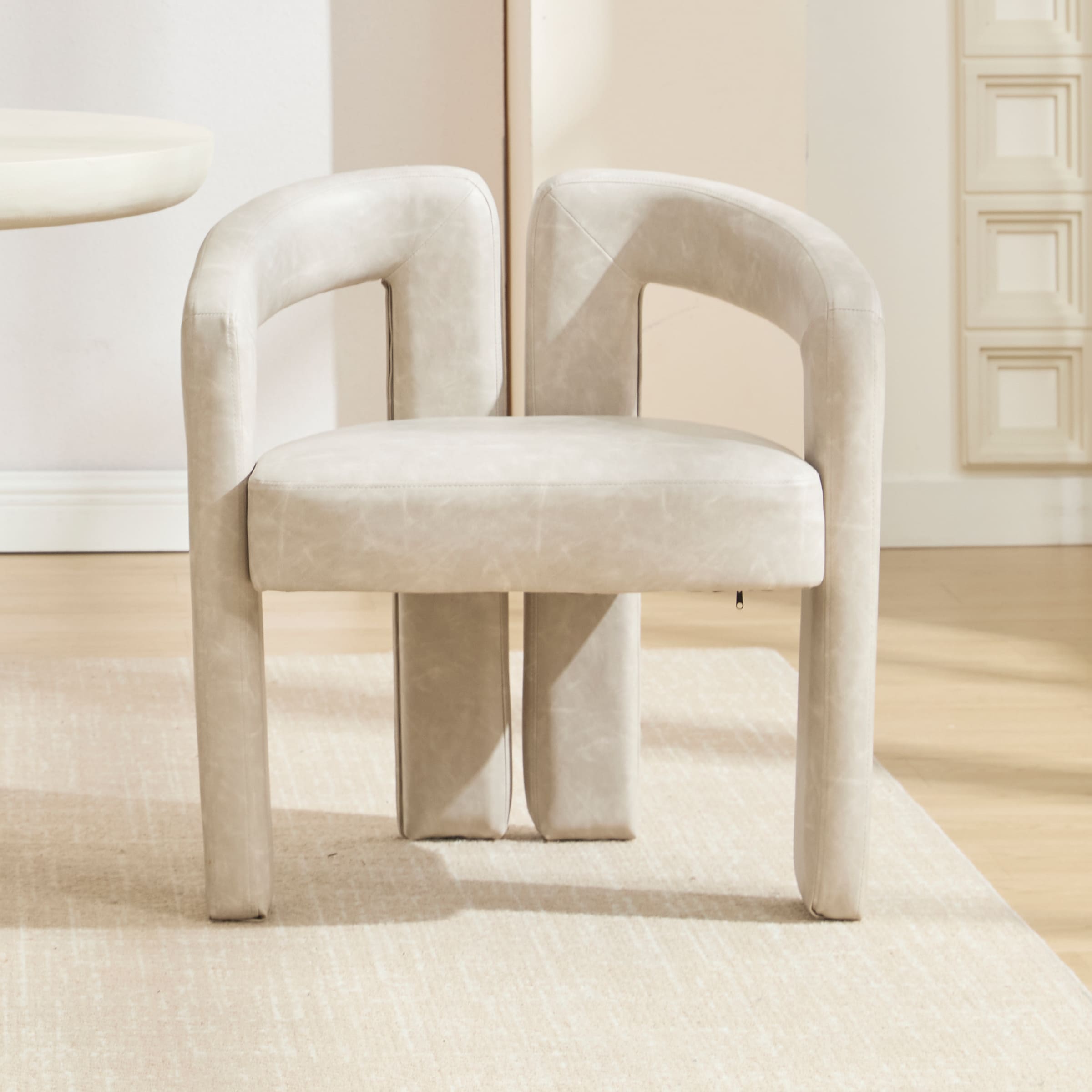 Group of six velvet khaki dining chairs around a table