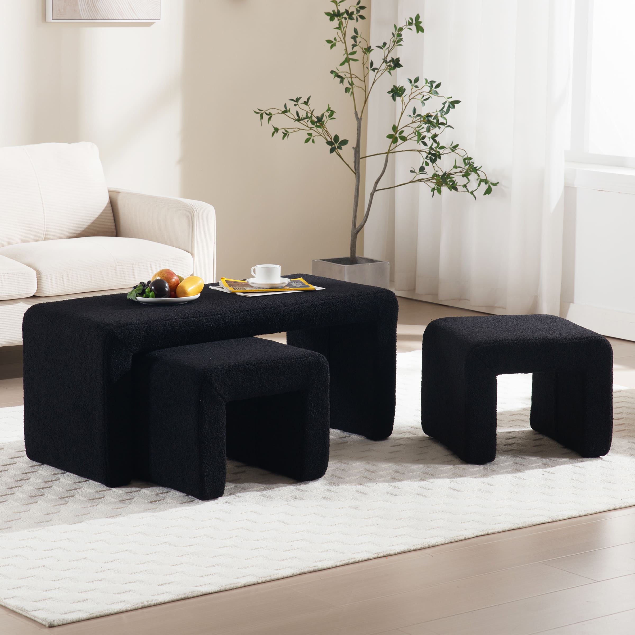 Front view of black boucle ottoman bench with two stools