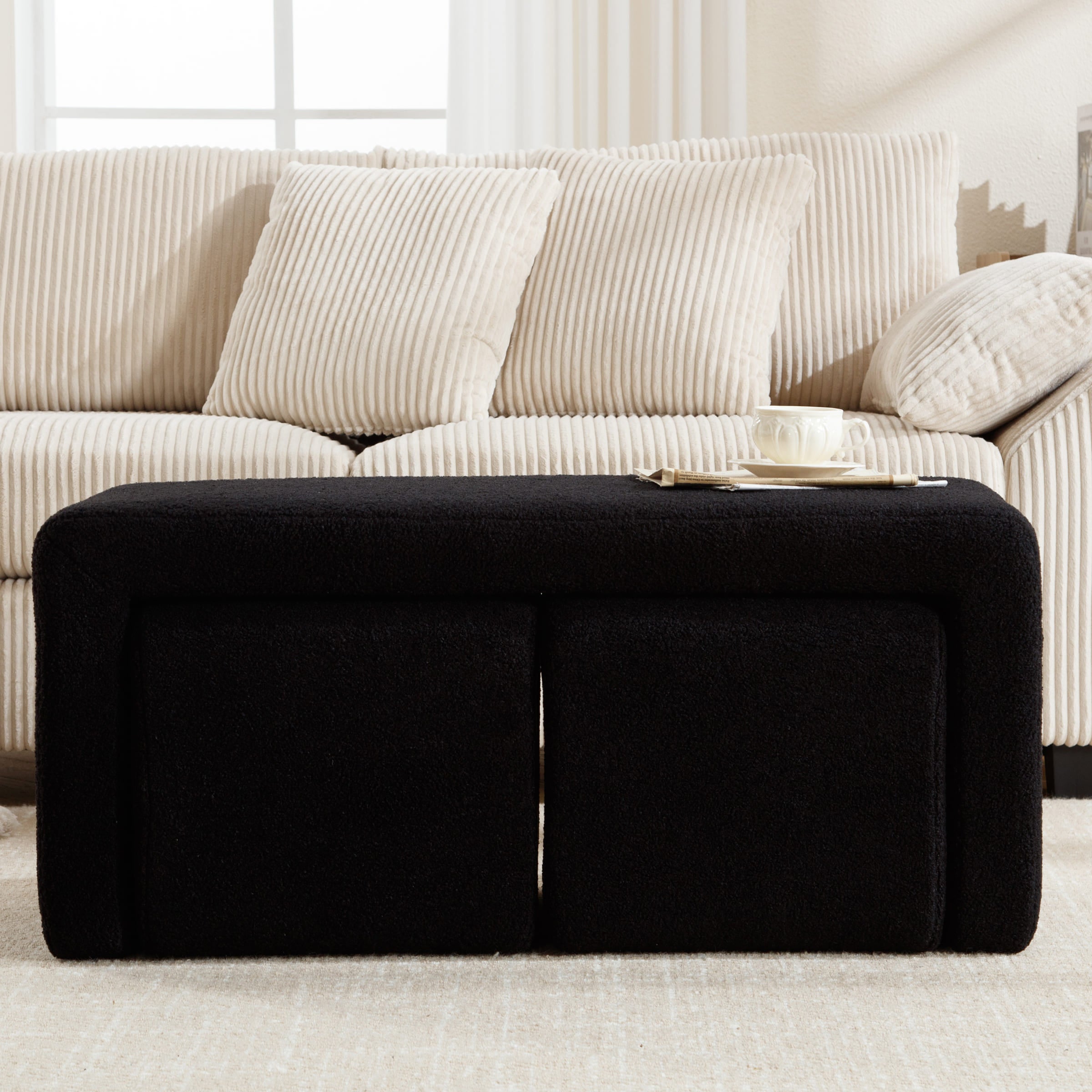 Close-up view of black boucle ottoman bench surface