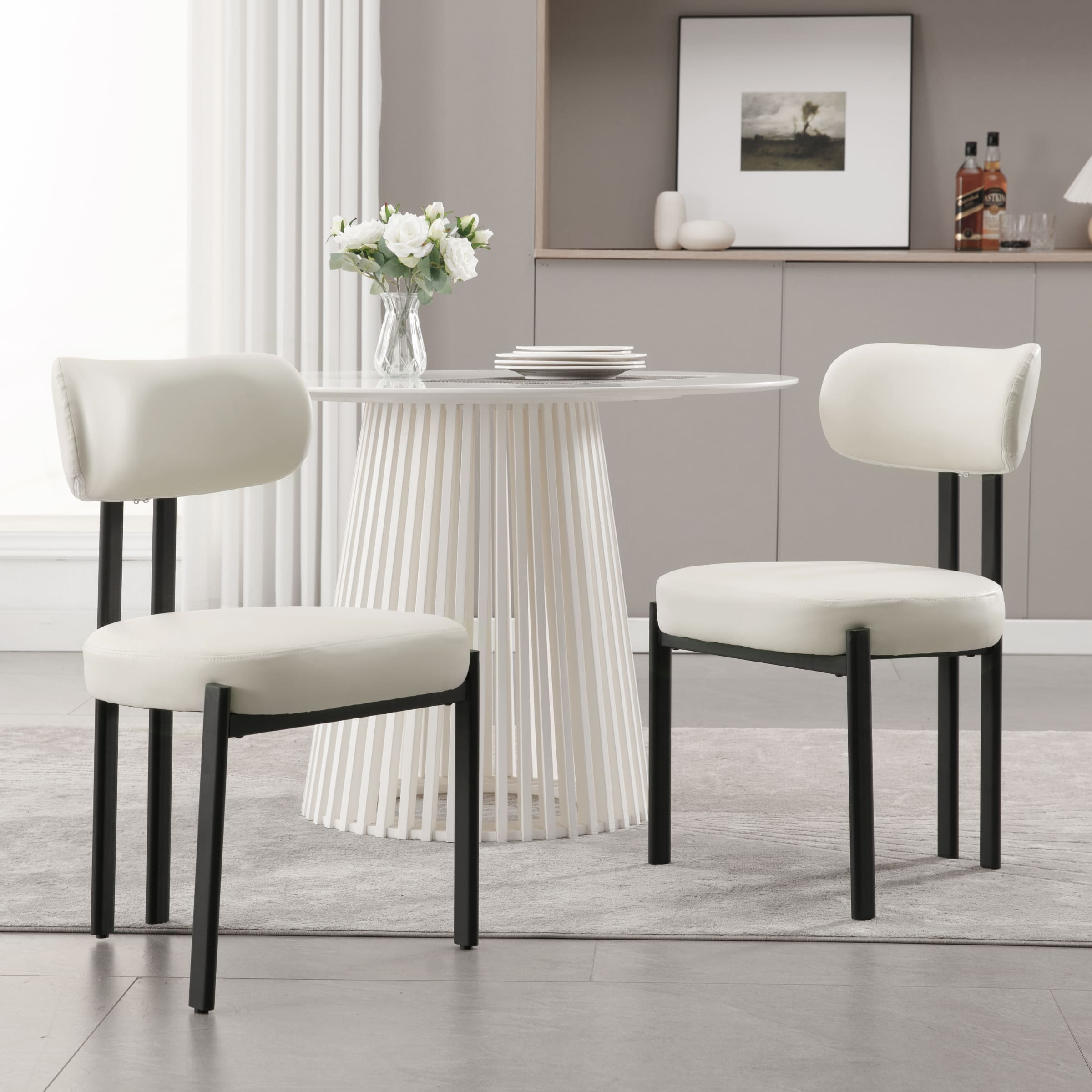 Chairs placed around round modern table with flowers