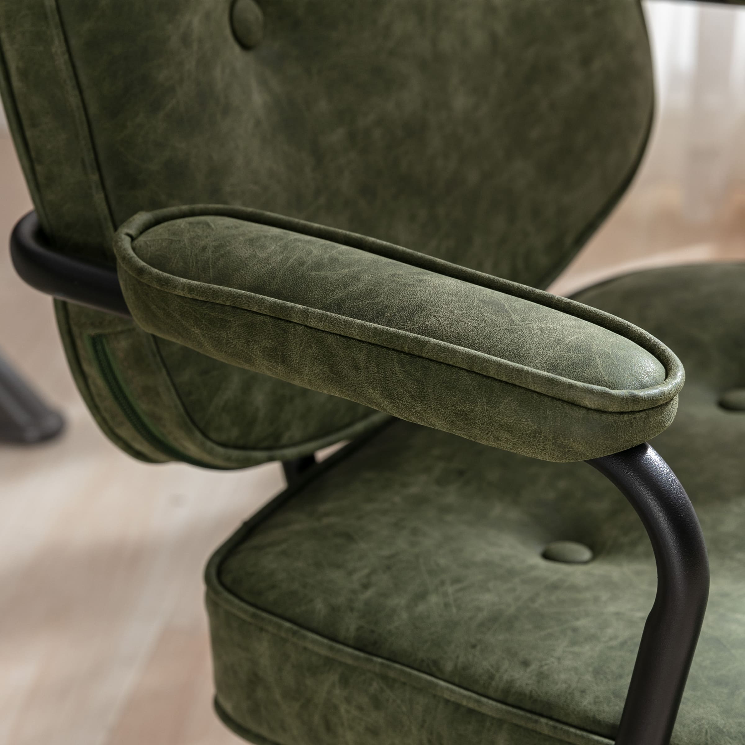 Armrest and side of green chair