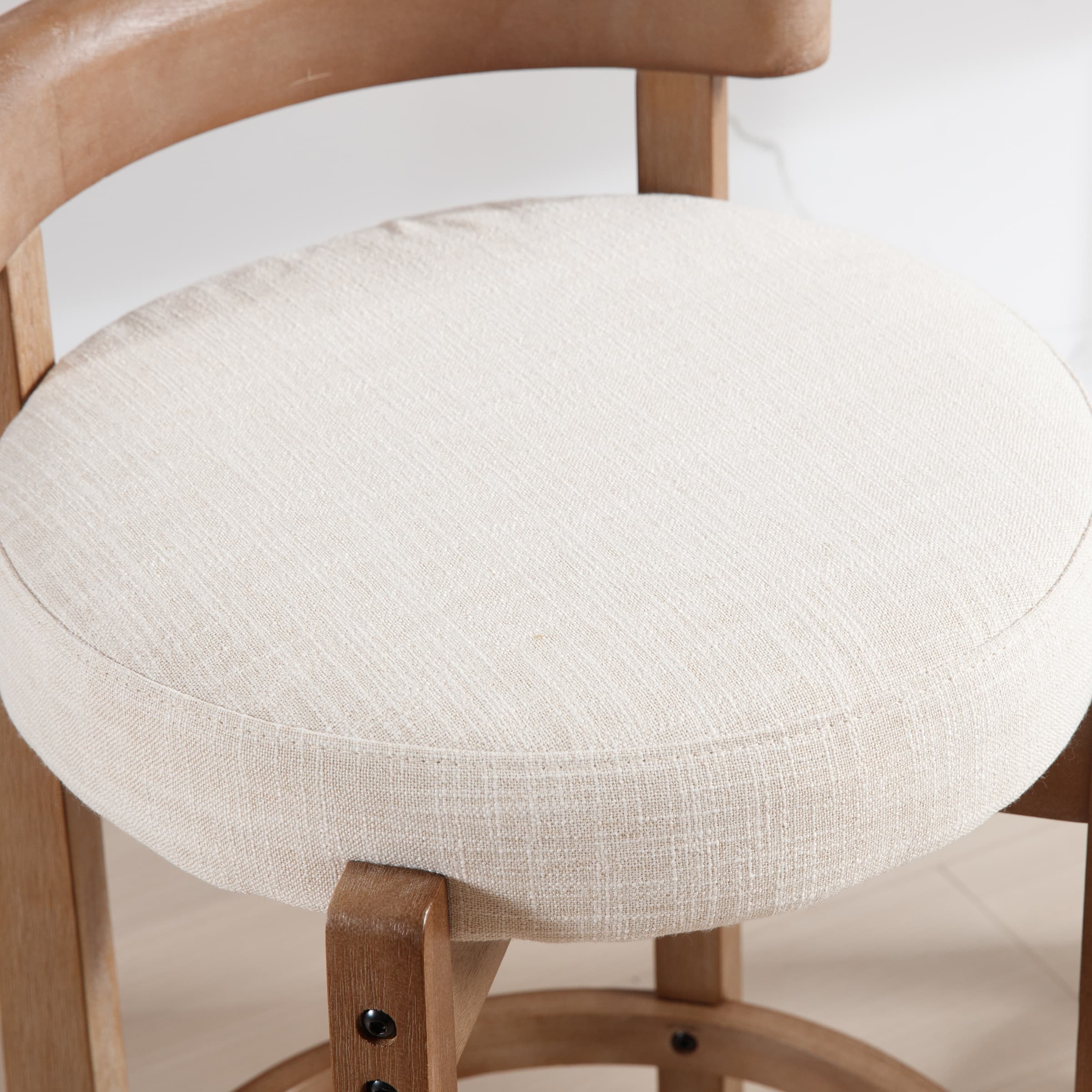 Close-up of beige upholstered round seat cushion