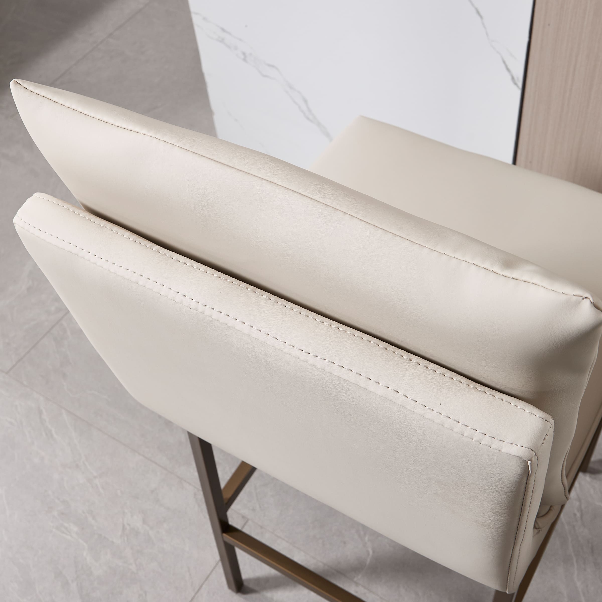 Back and top edges of cream leather seat cushions