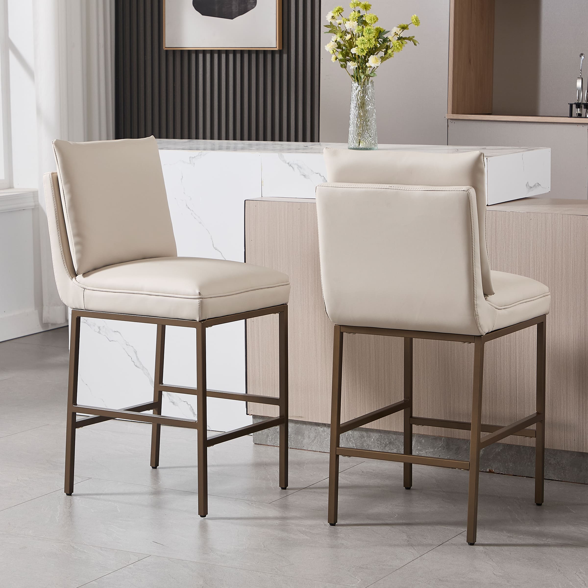 Side and back view of two cream leather counter-height stools