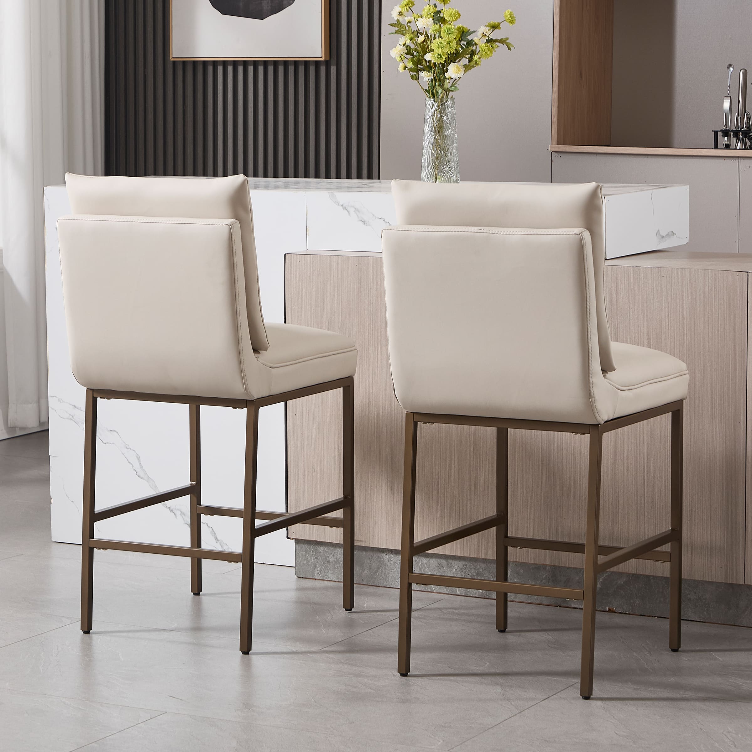 Rear and side views of two cream leather bar stools