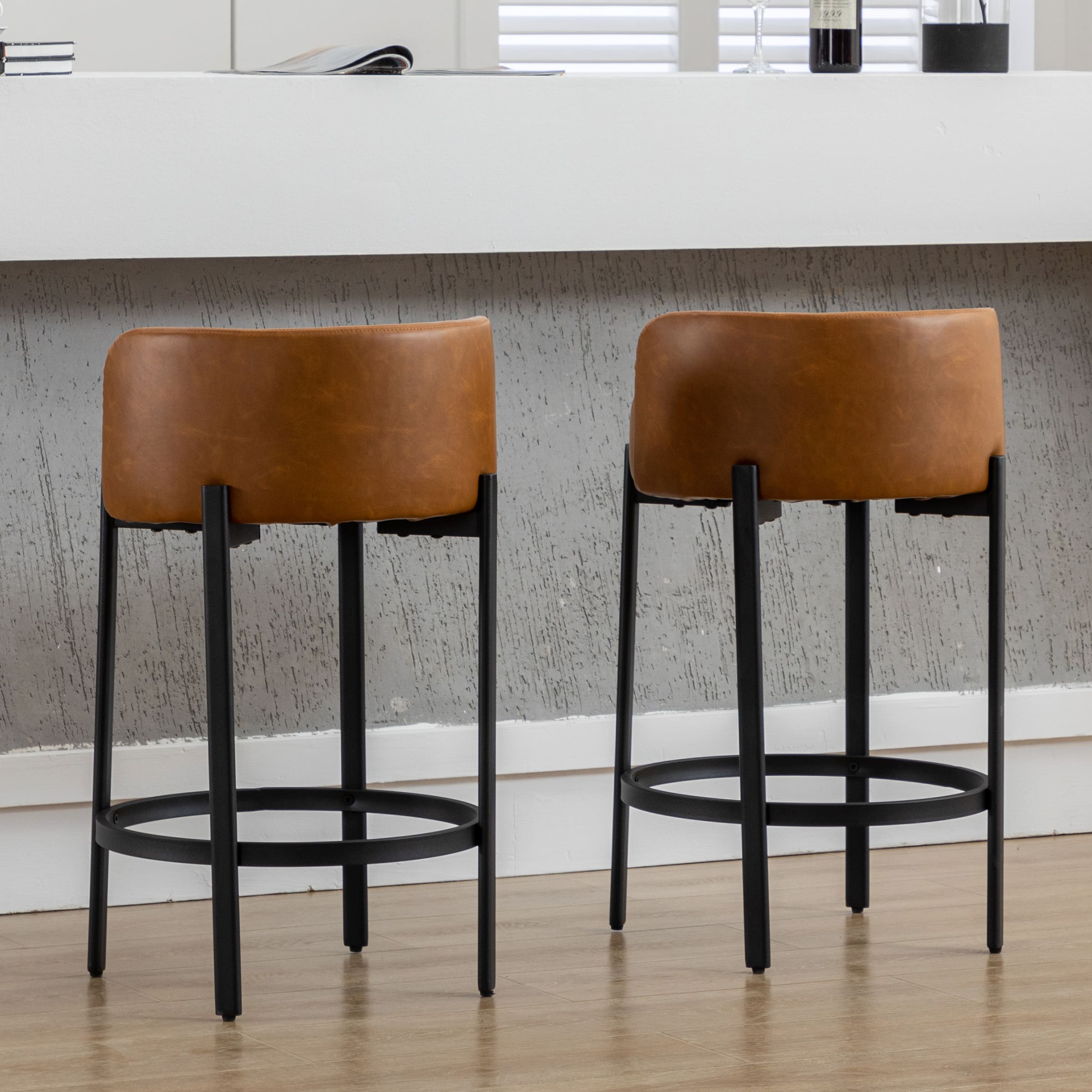 Two stools from side showing back