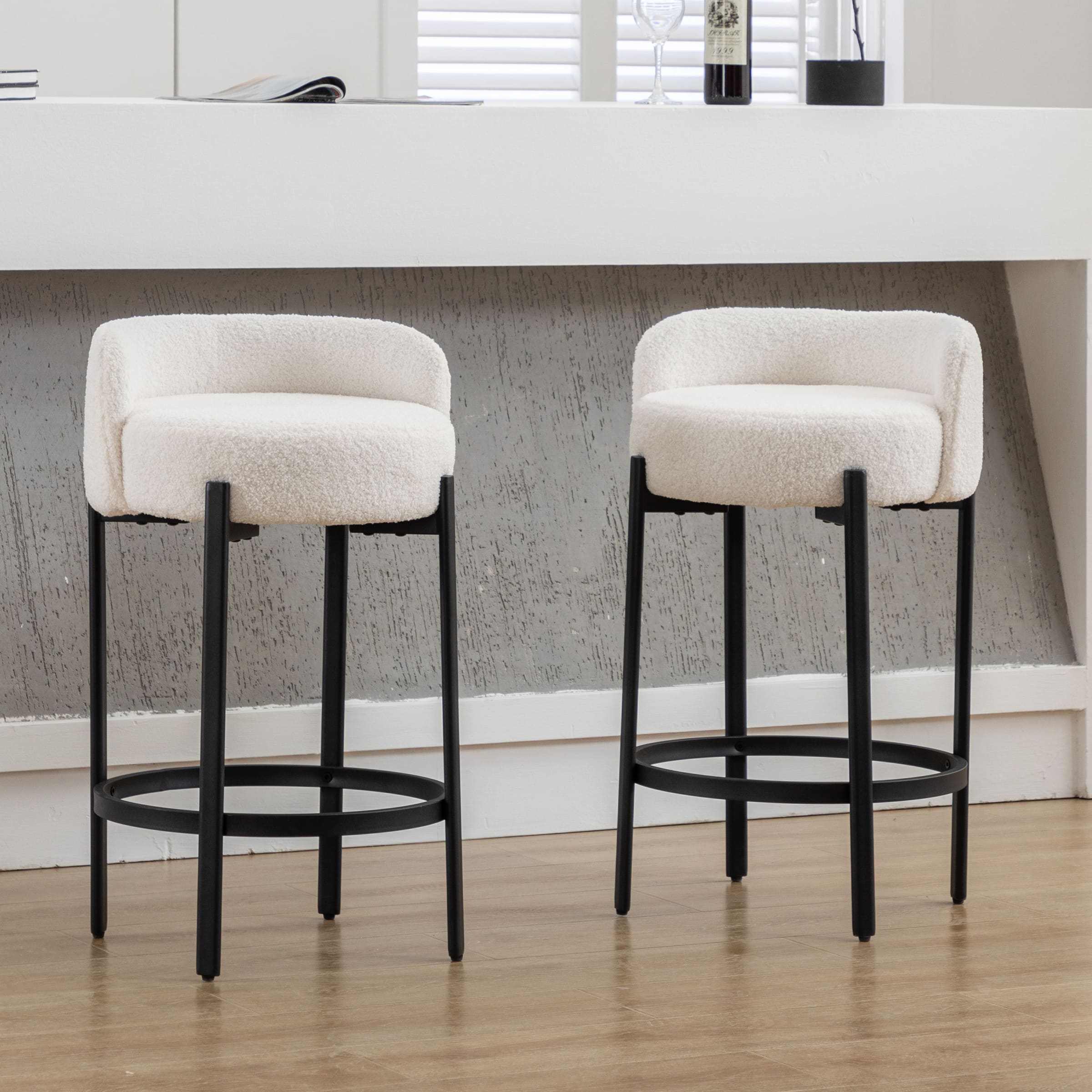 Two white stools to the left of brown stools
