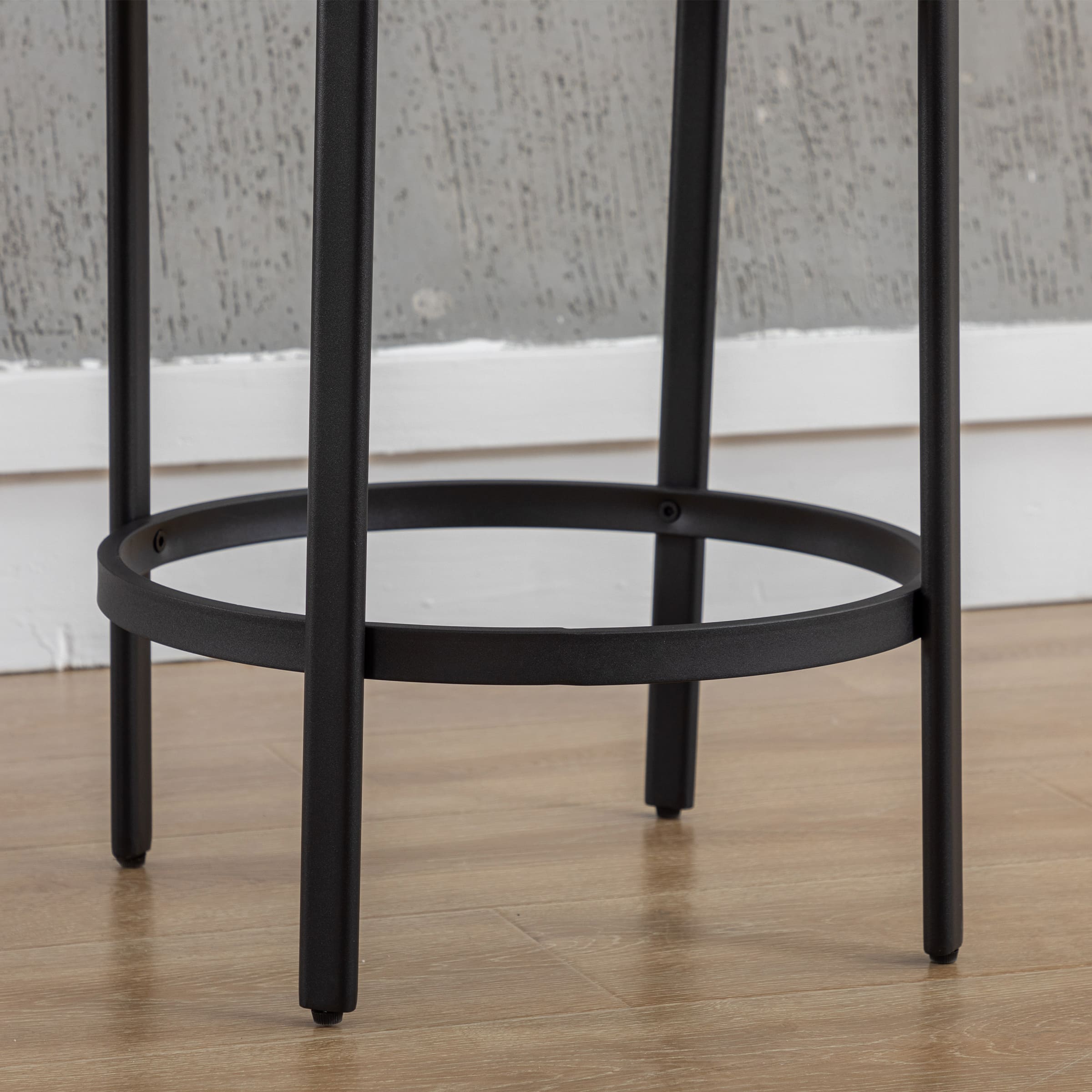 Circular metal footrest ring between legs