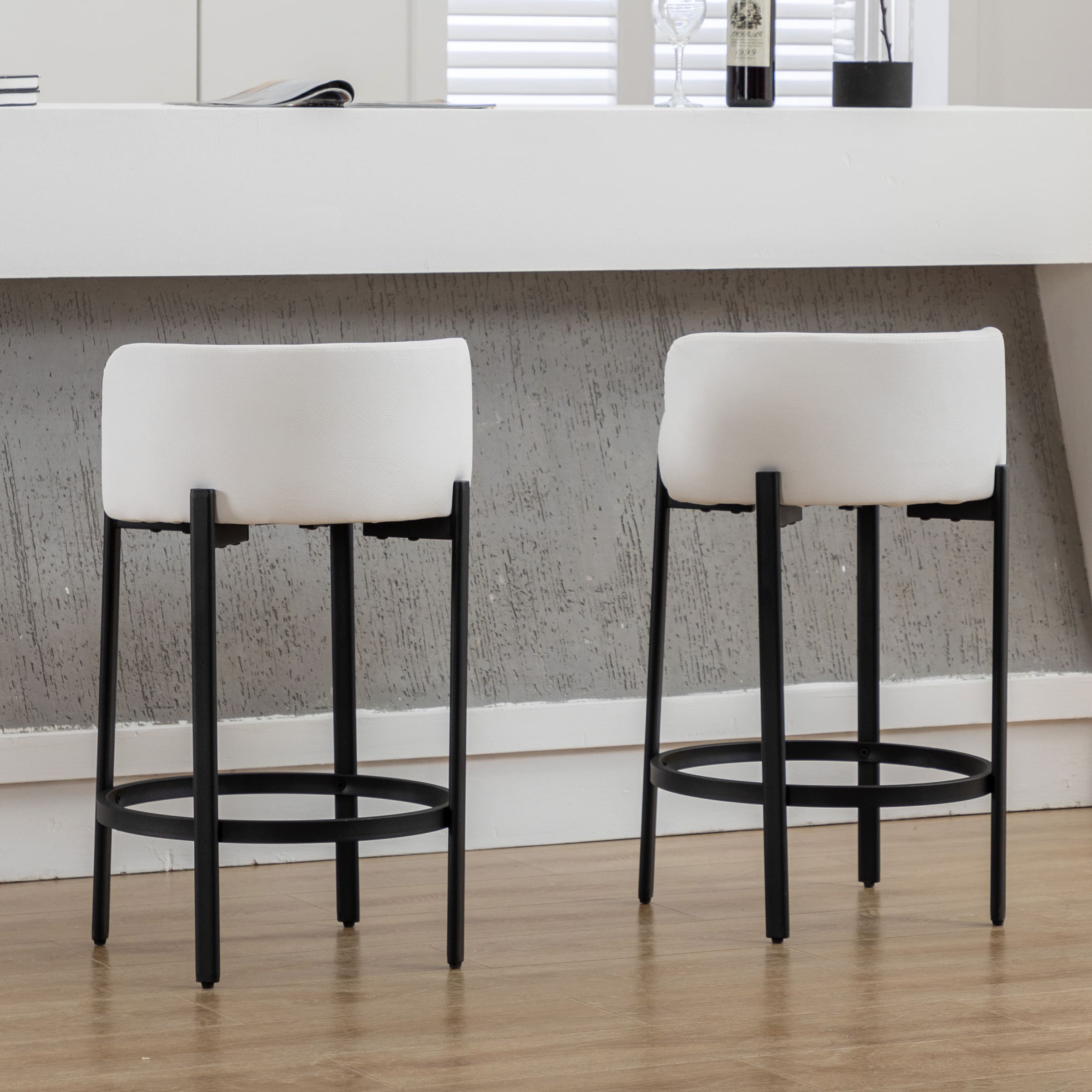 Two white low-back counter stools side by side
