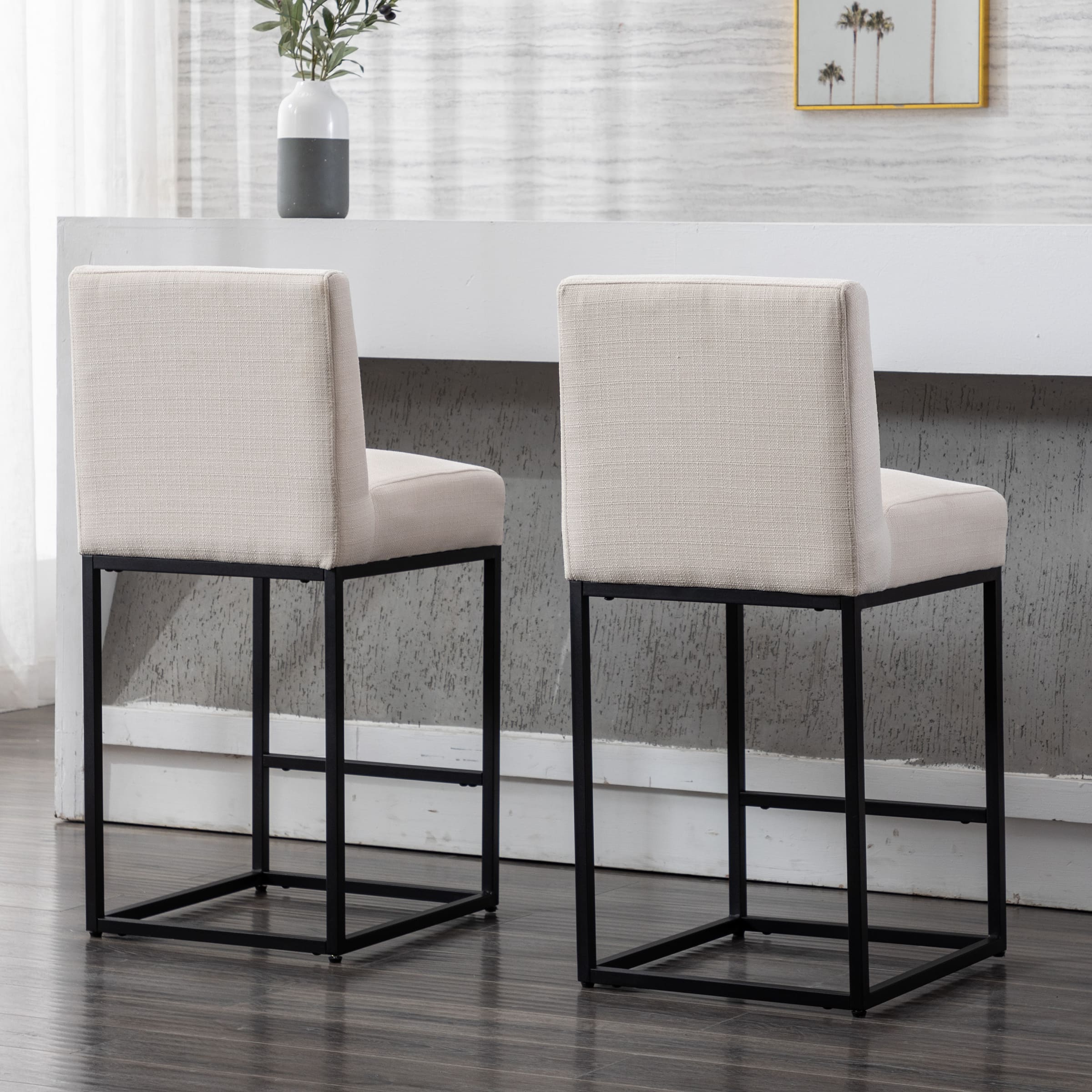 Two beige stools shown from side/back