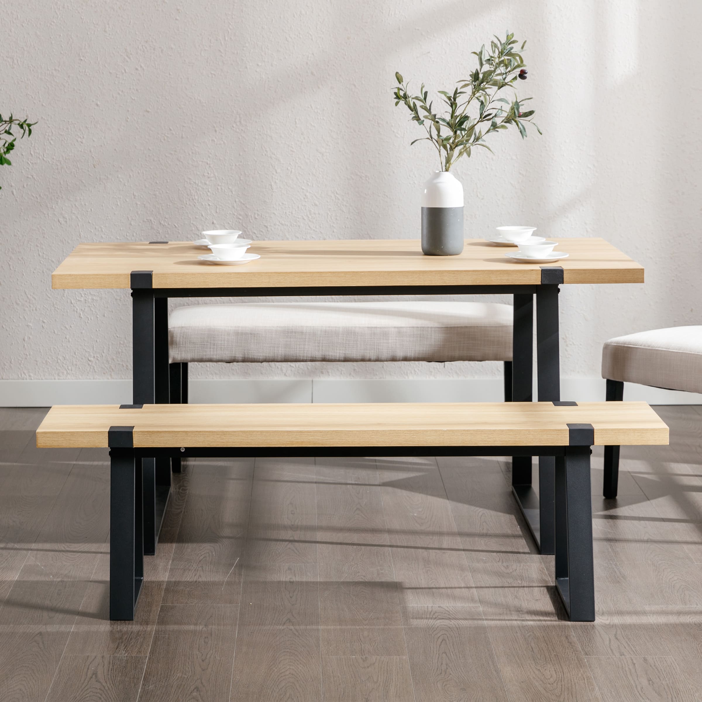 Small dining bench under table with plant