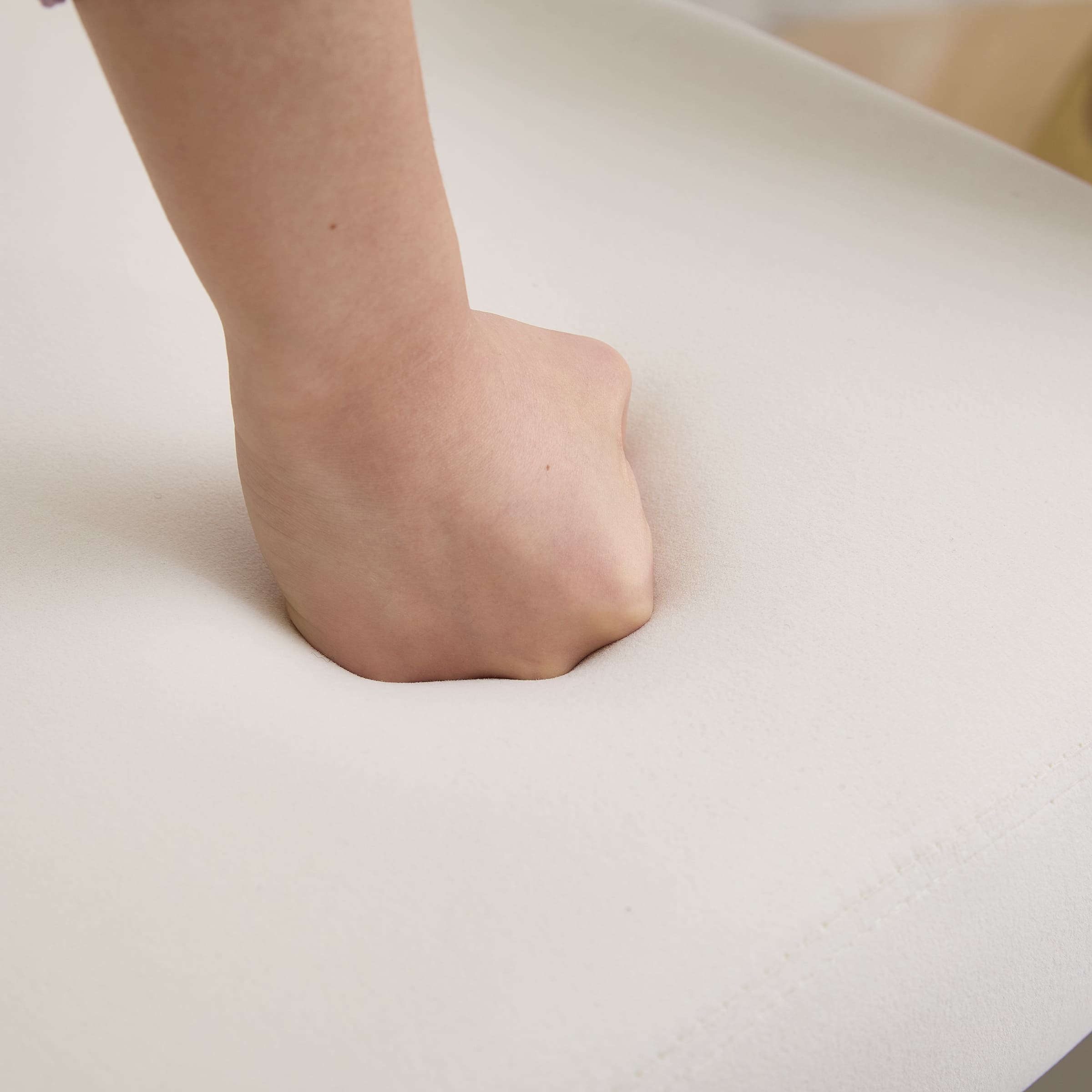 Hand pressing upholstery to show softness