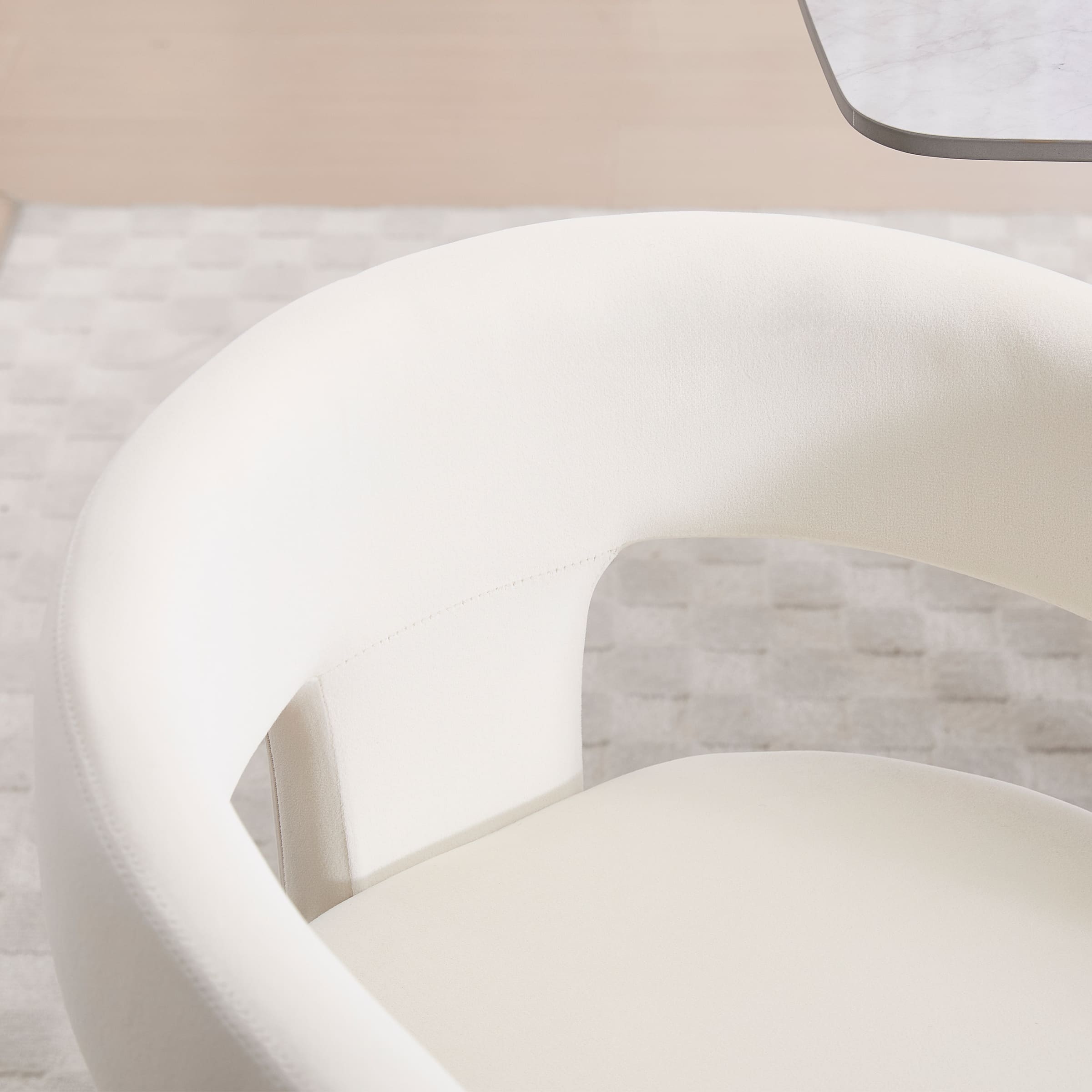Close-up of chair upholstery and arm curve