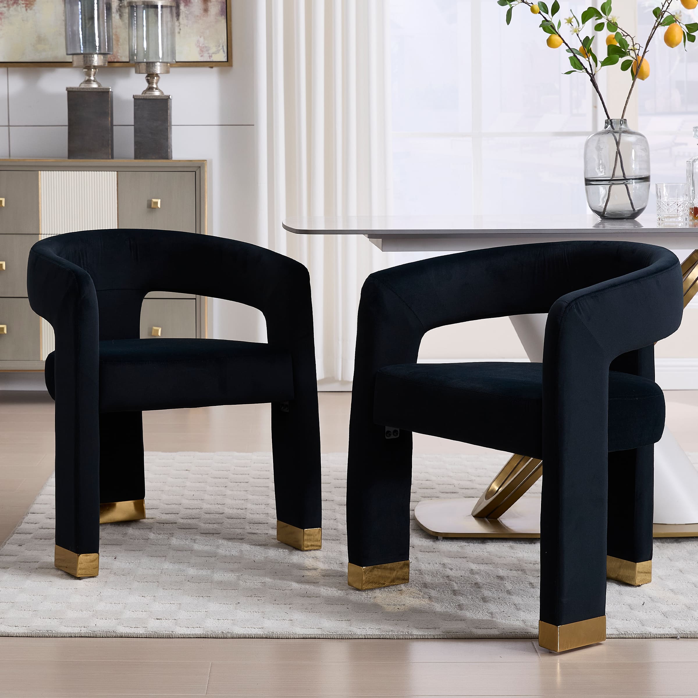Two dark blue velvet chairs around a table