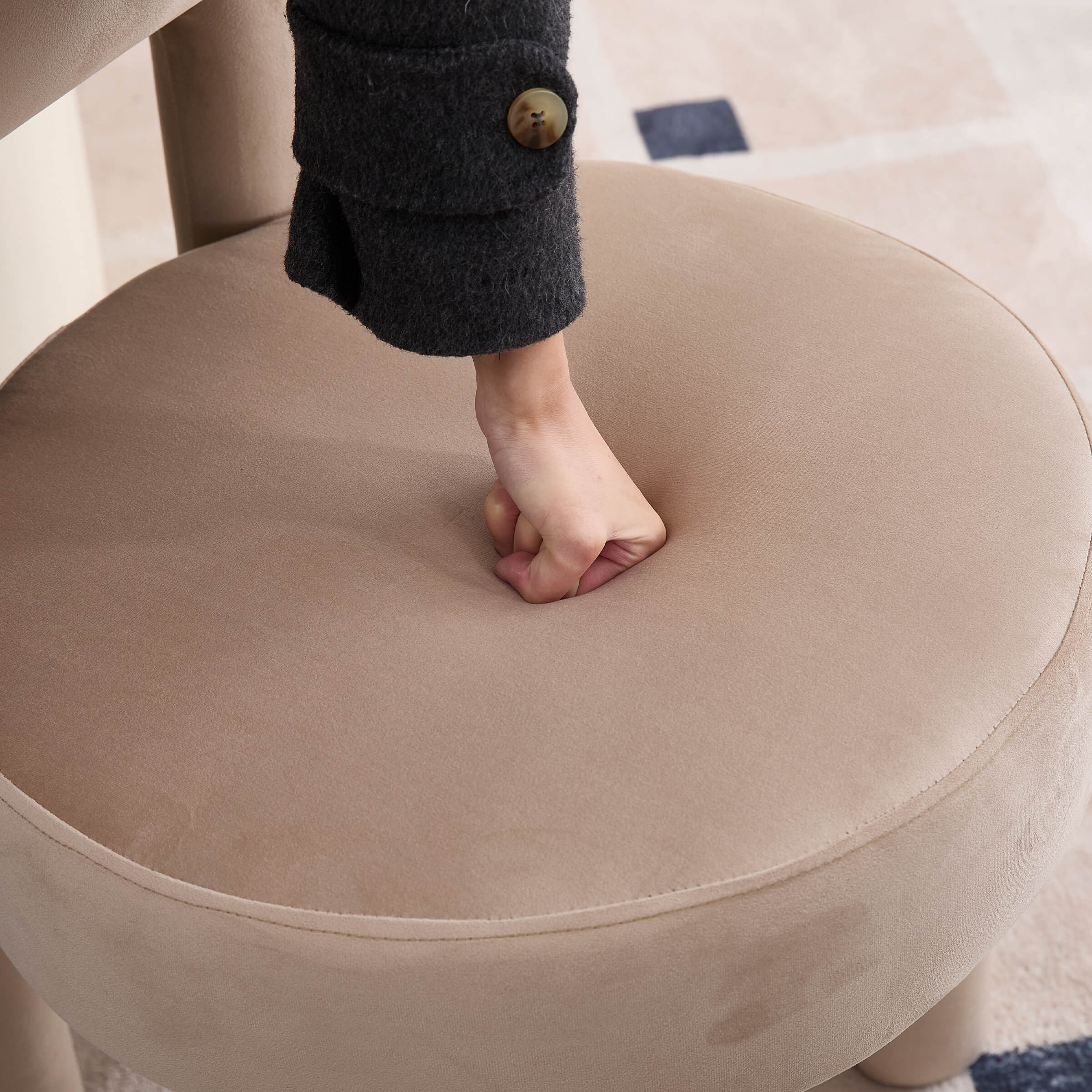 Person pressing into the round seat cushion