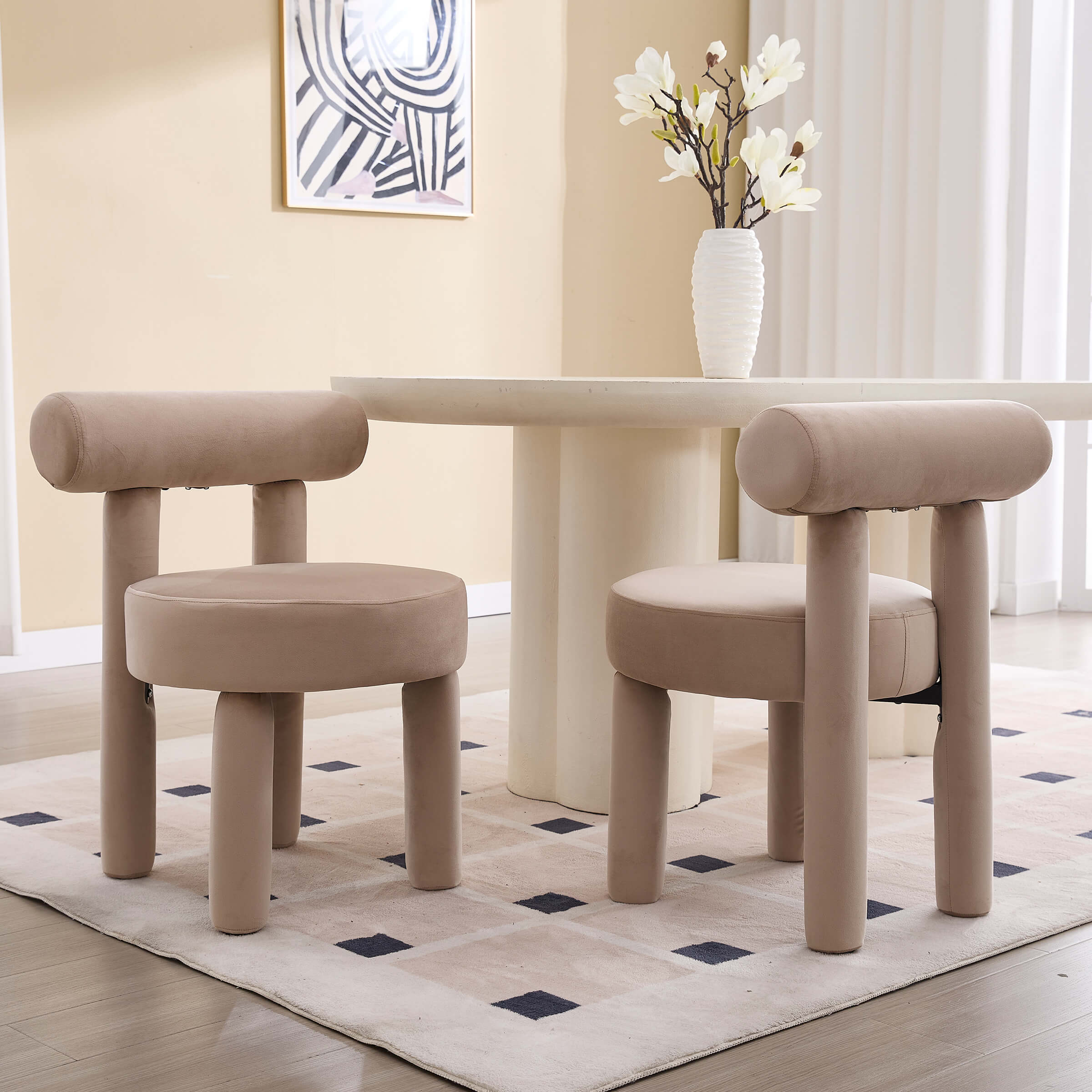 Beige velvet dining chairs with matching ottoman around a cream table