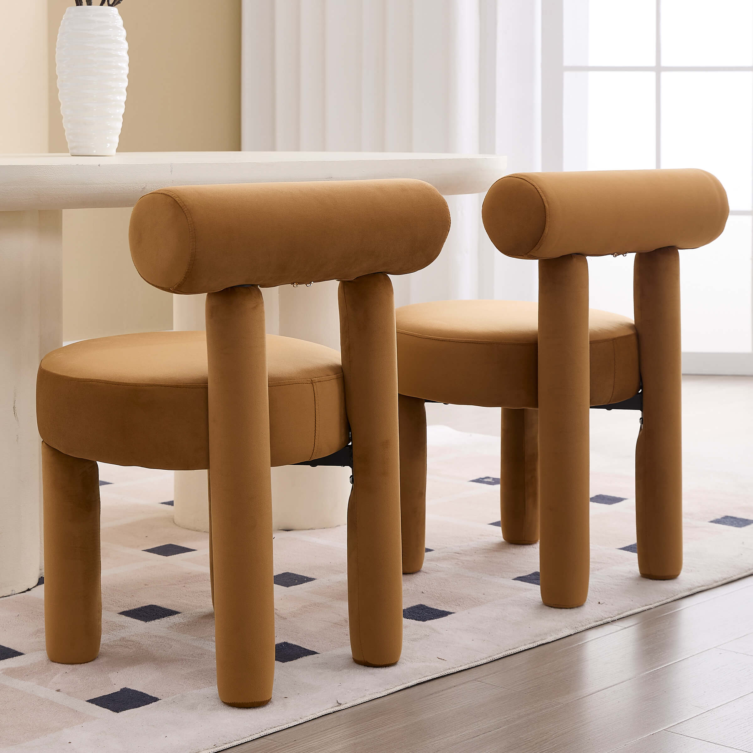 Two beige dining chairs around white table