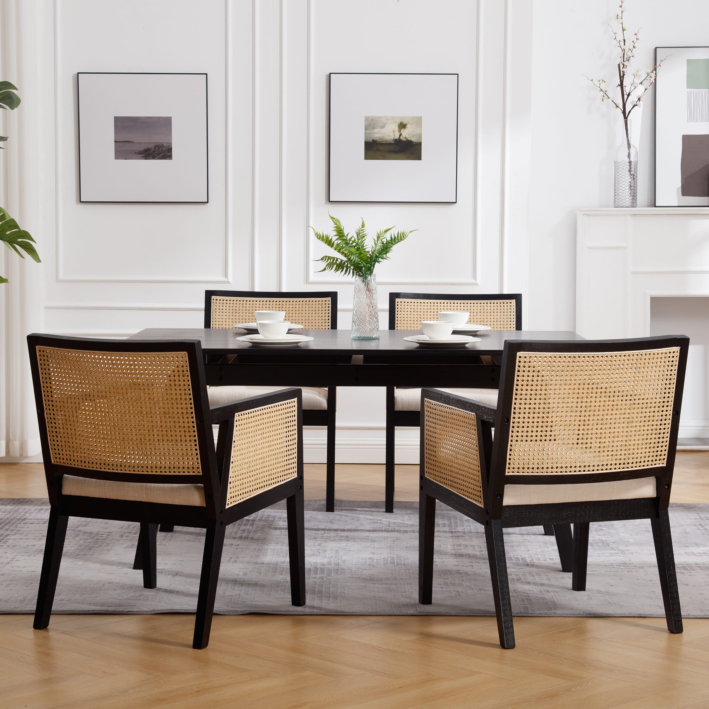 Chairs around a dining table in a white room
