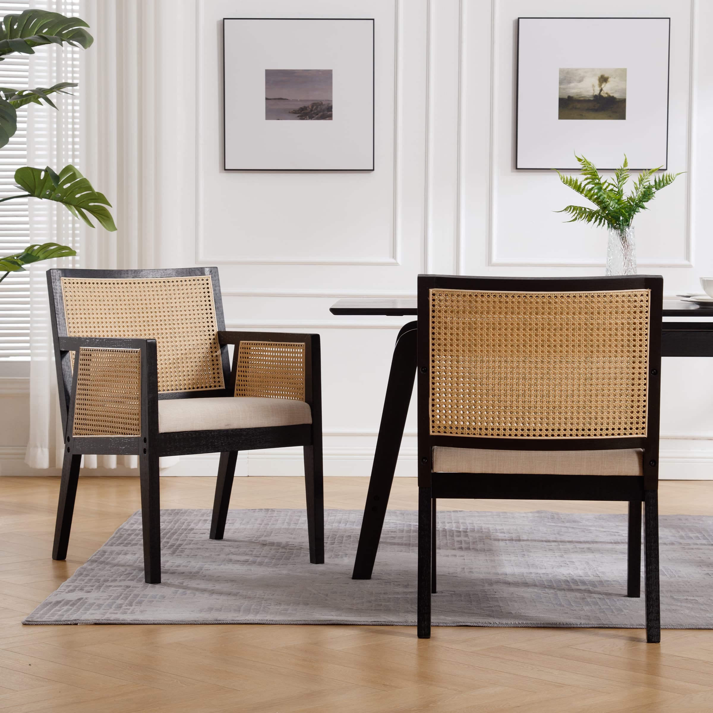 Chairs around a table in a bright white dining room