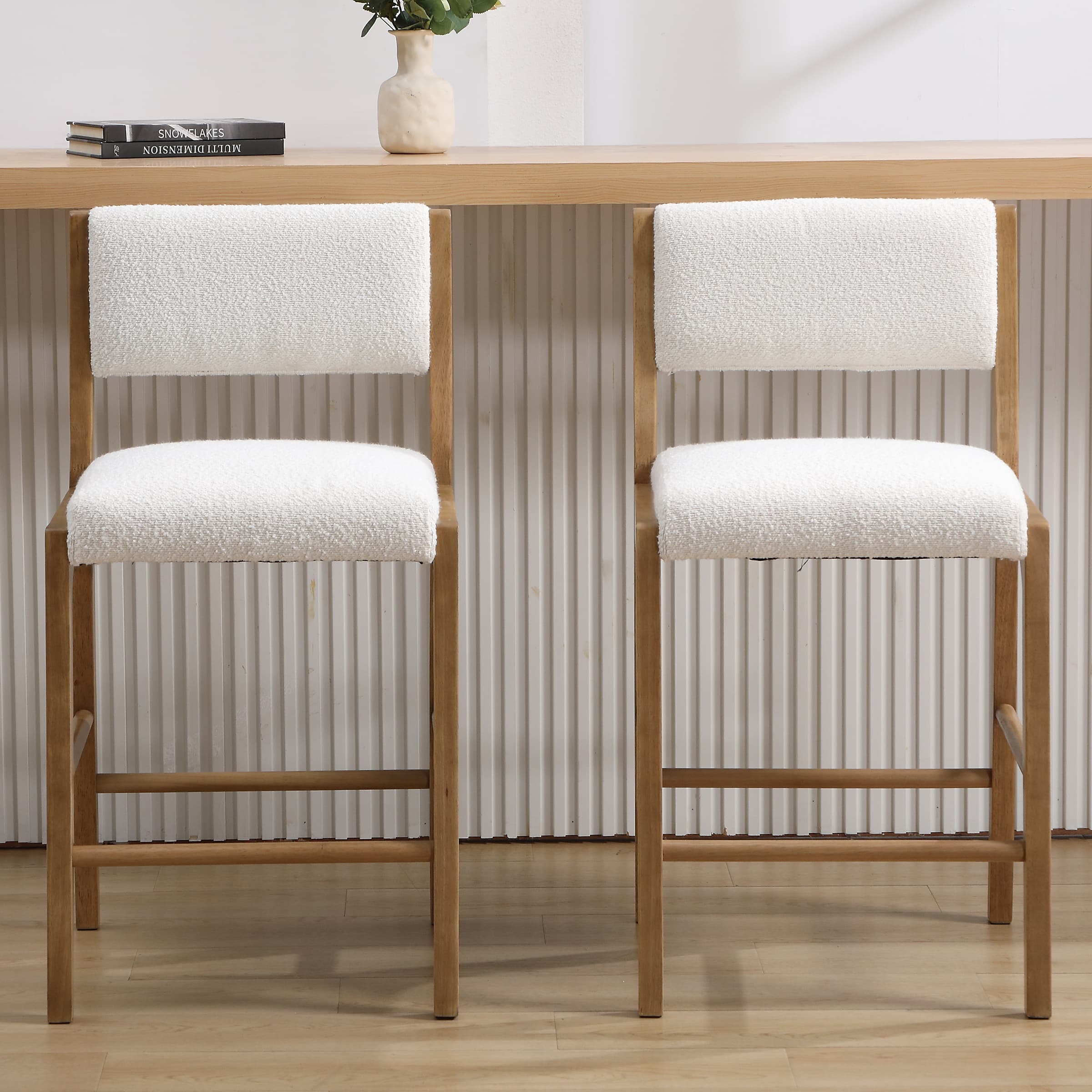 Front view of two beige upholstered counter stools