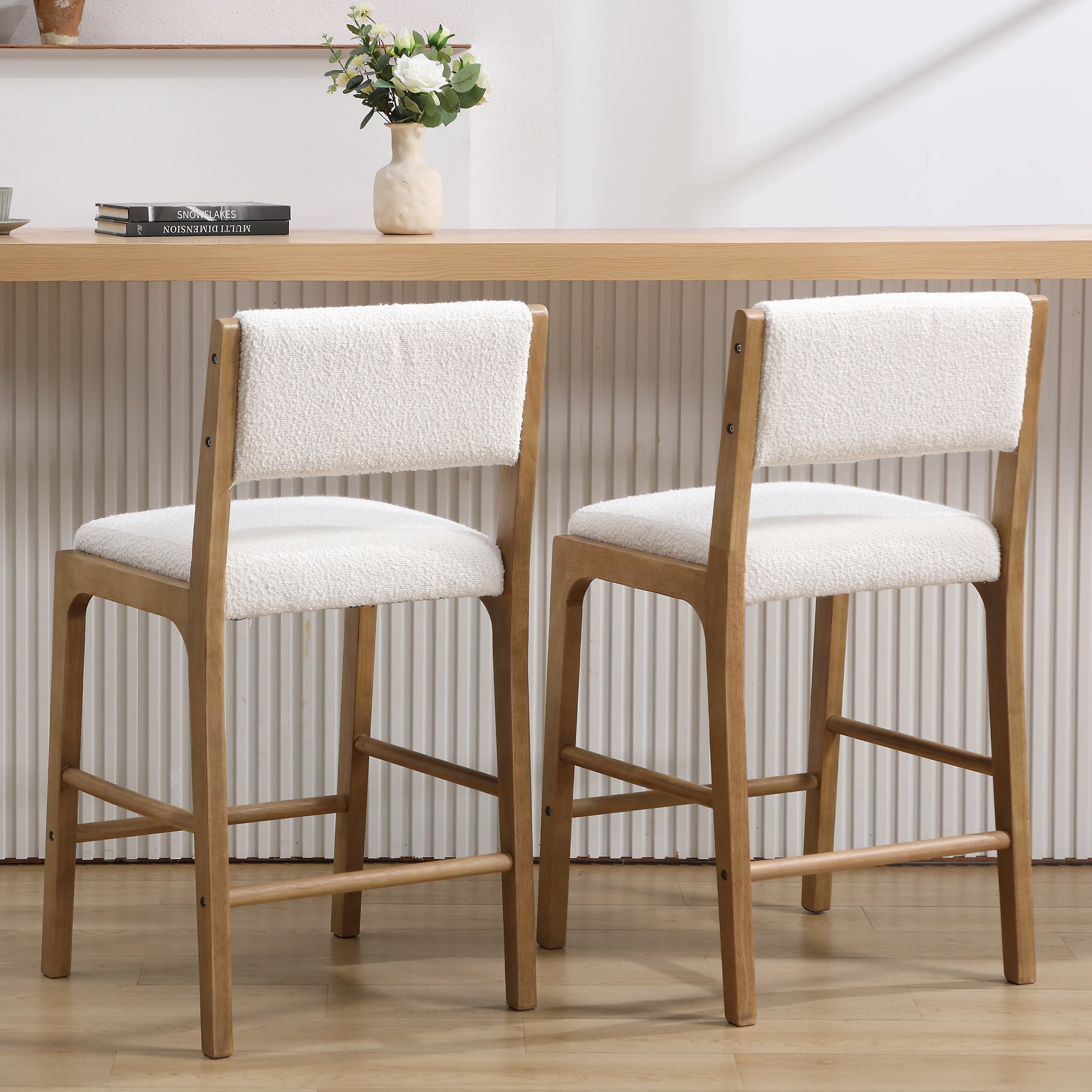Side view of two beige upholstered counter stools