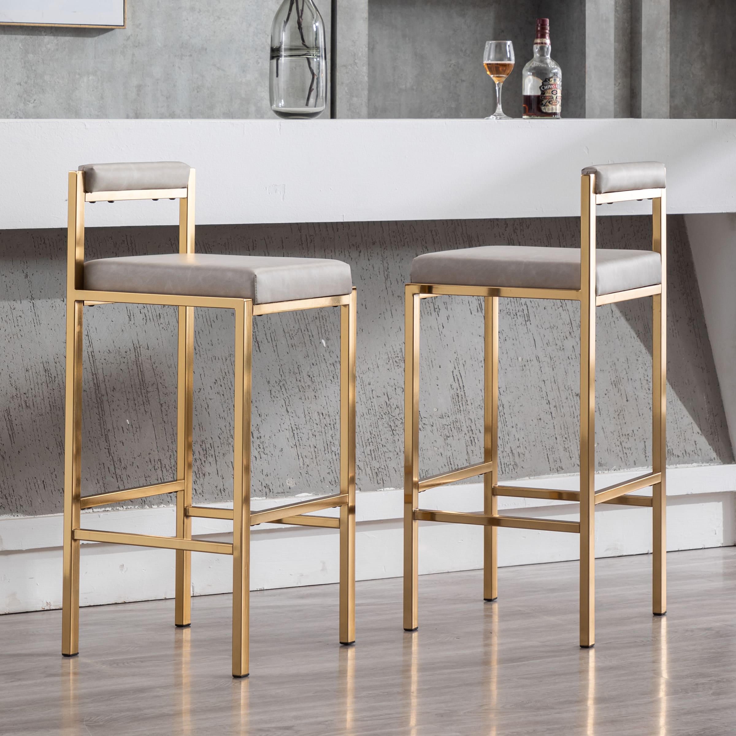 Two stools with white cushions near bar