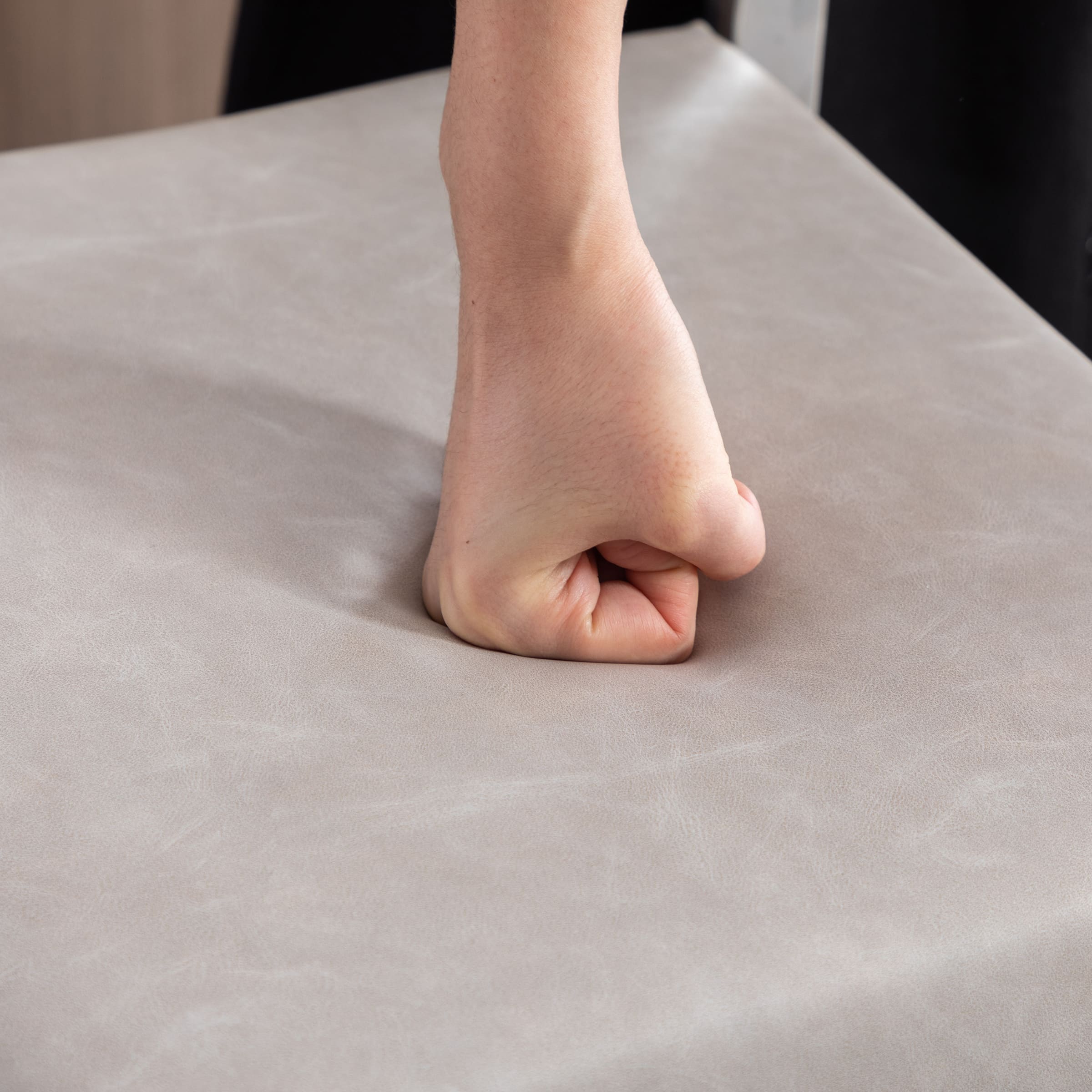 Hand pressing beige cushion