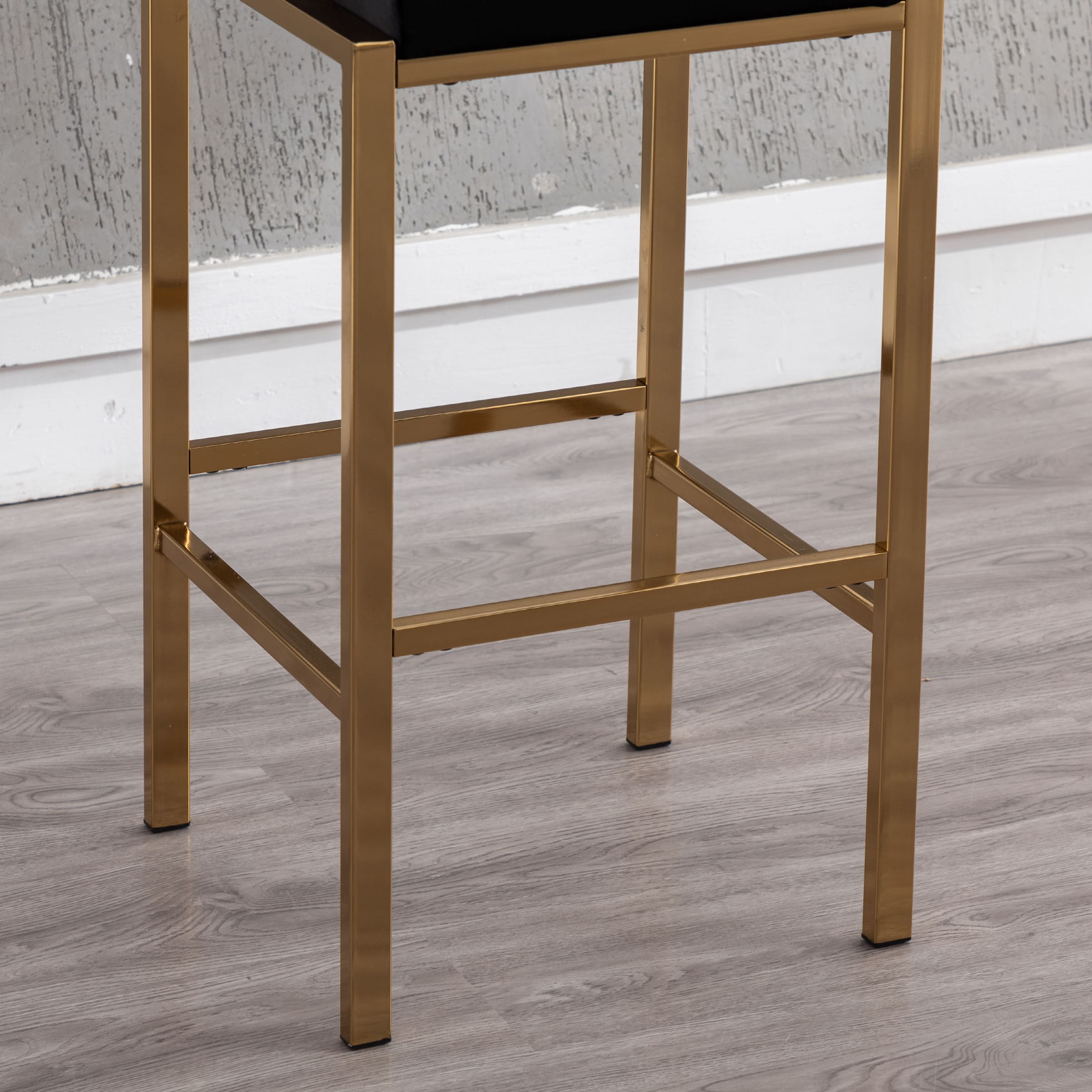 Lower legs and footrest of gold bar stool