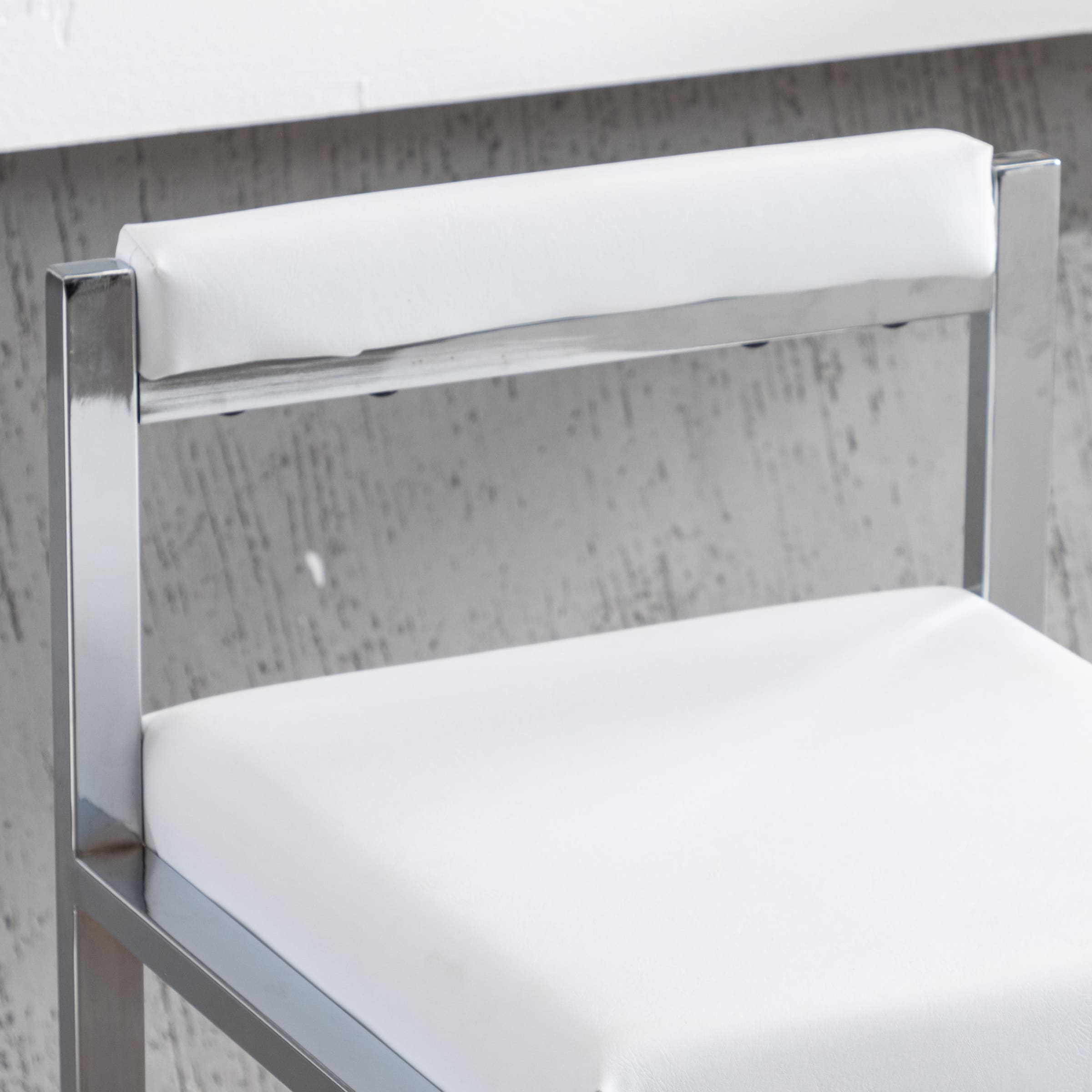 Close-up of chrome chair seat
