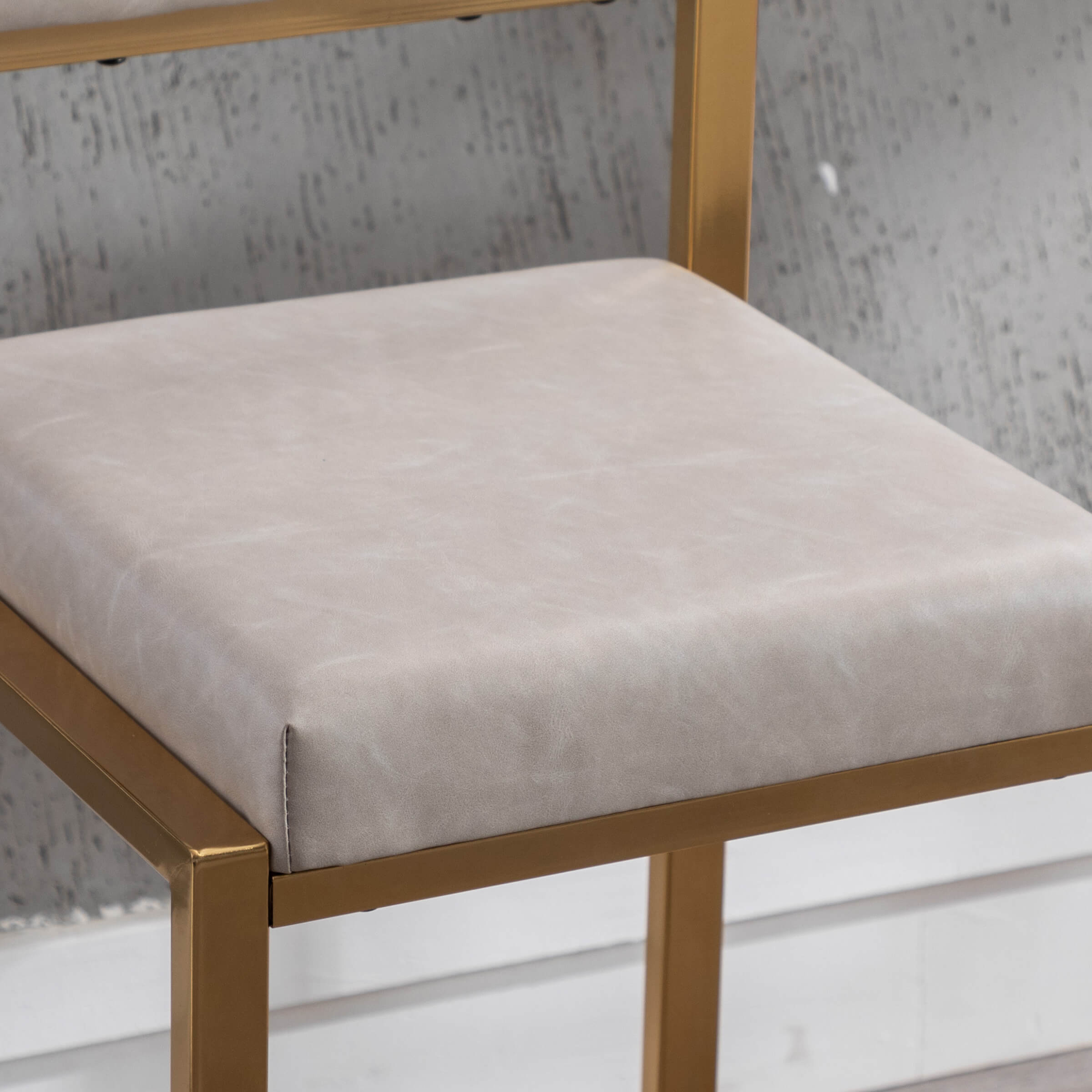 Close-up of beige cushion on white chair