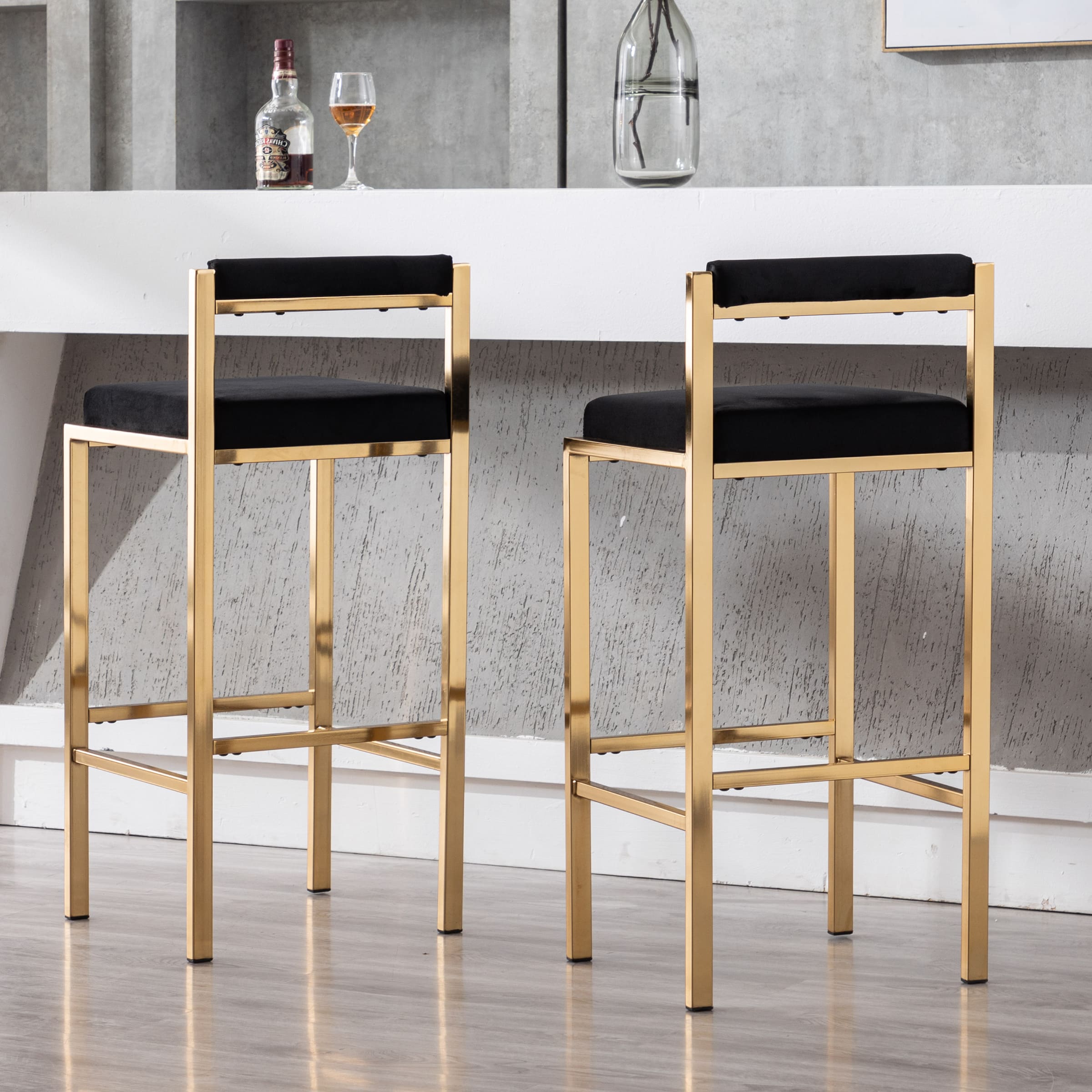 Two gold bar stools in front of bar counter