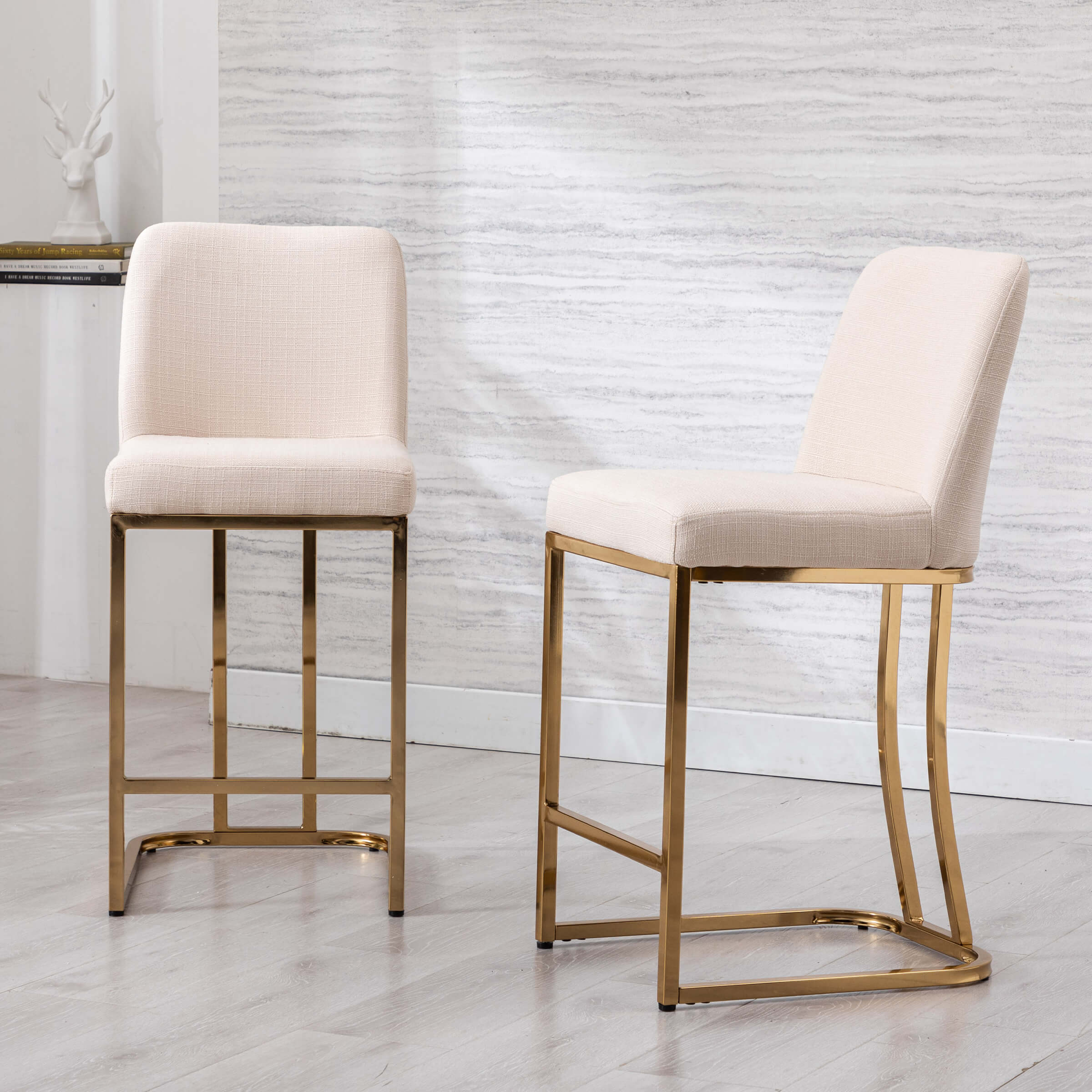 Cream chairs with gold frames in white and grey setting