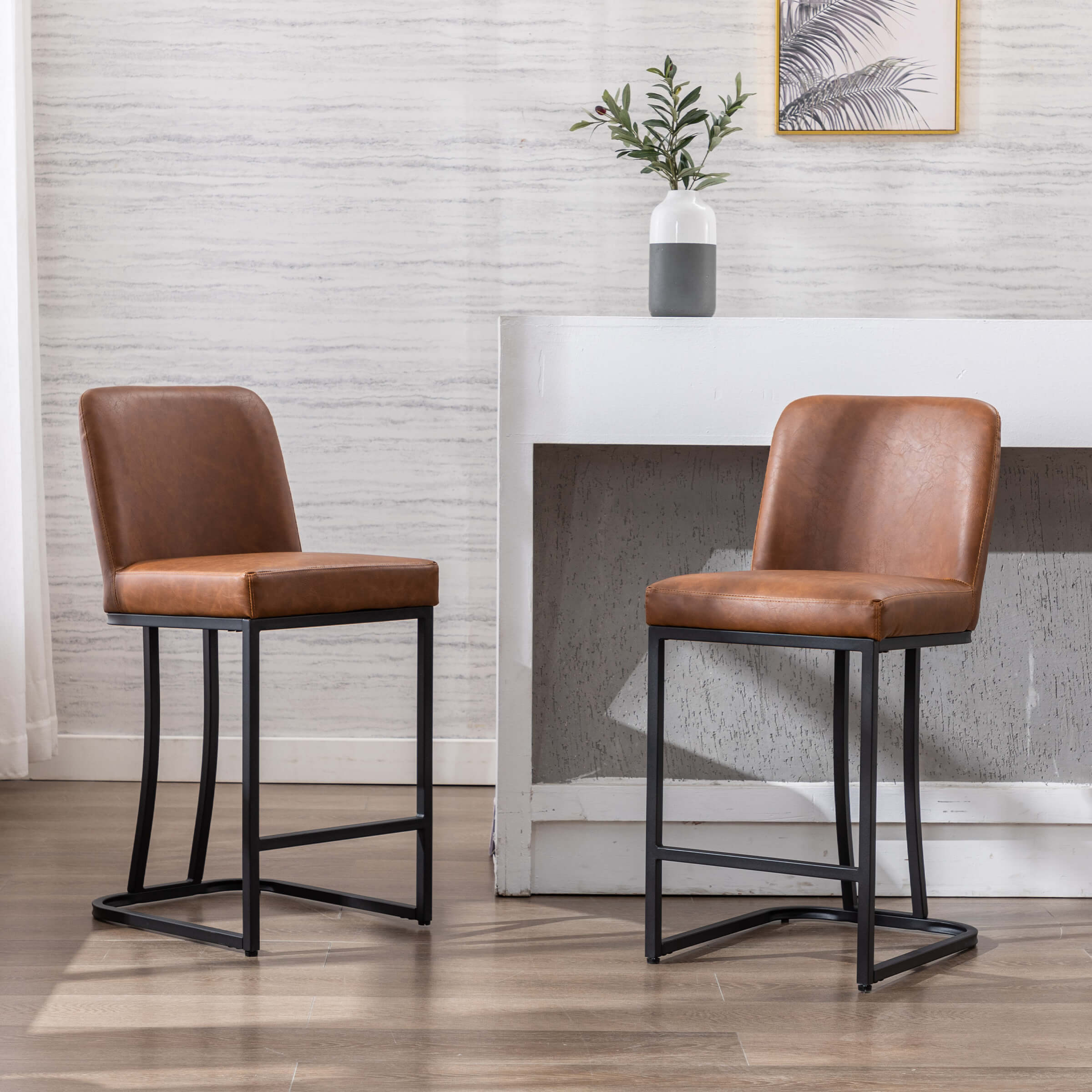 Two brown leather bar stools