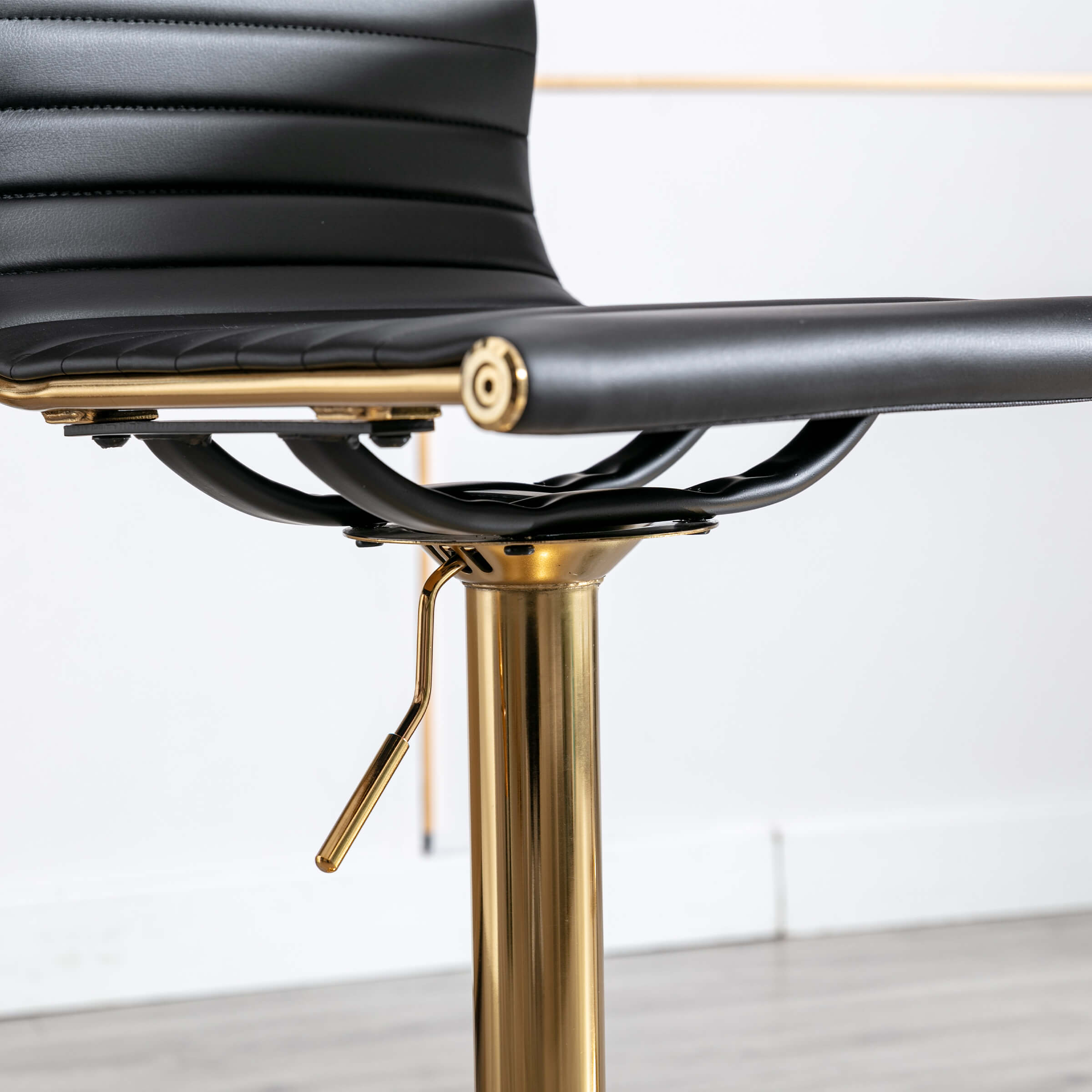 Close-up of screw and adjustment lever on stool