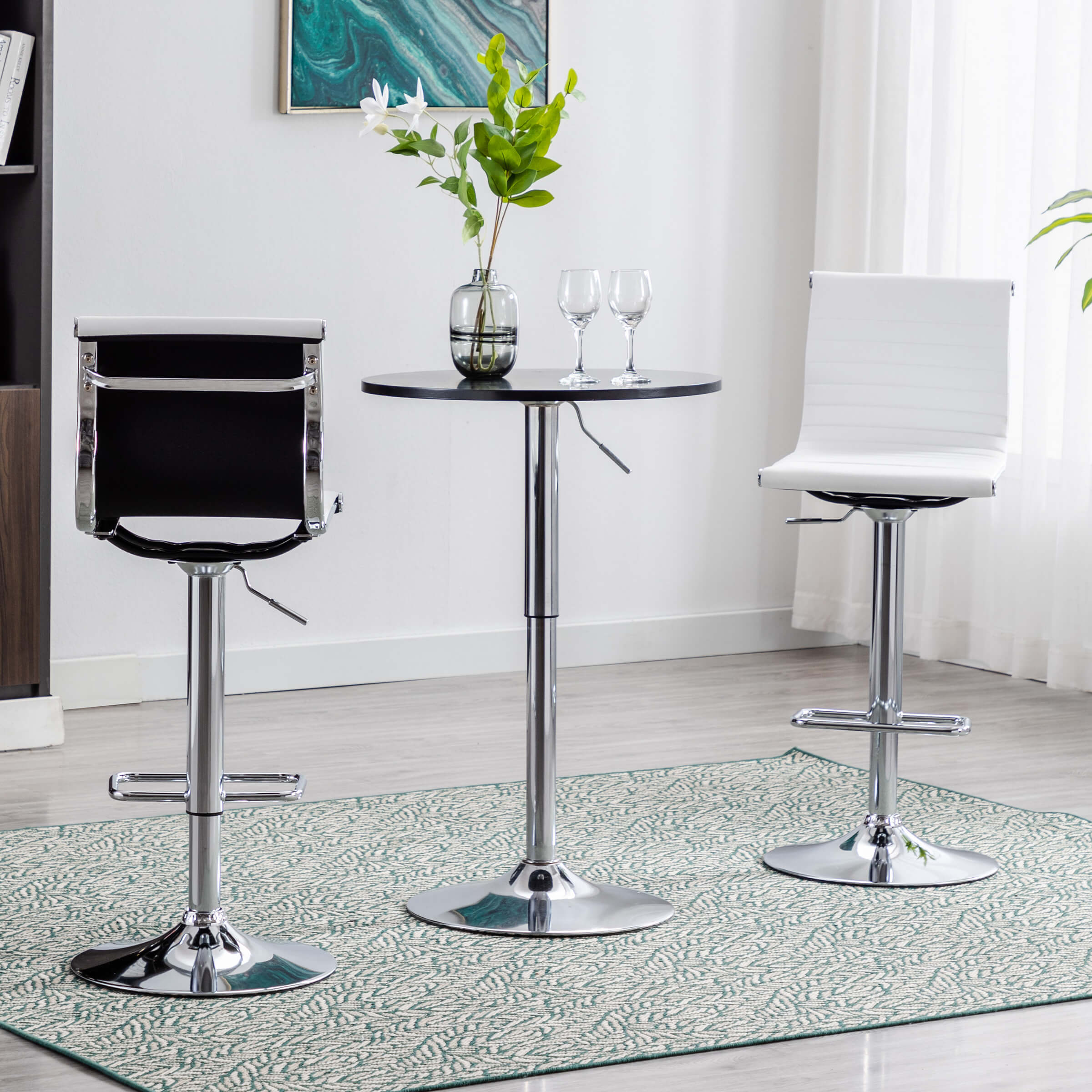 Round table with two bar stools beside it
