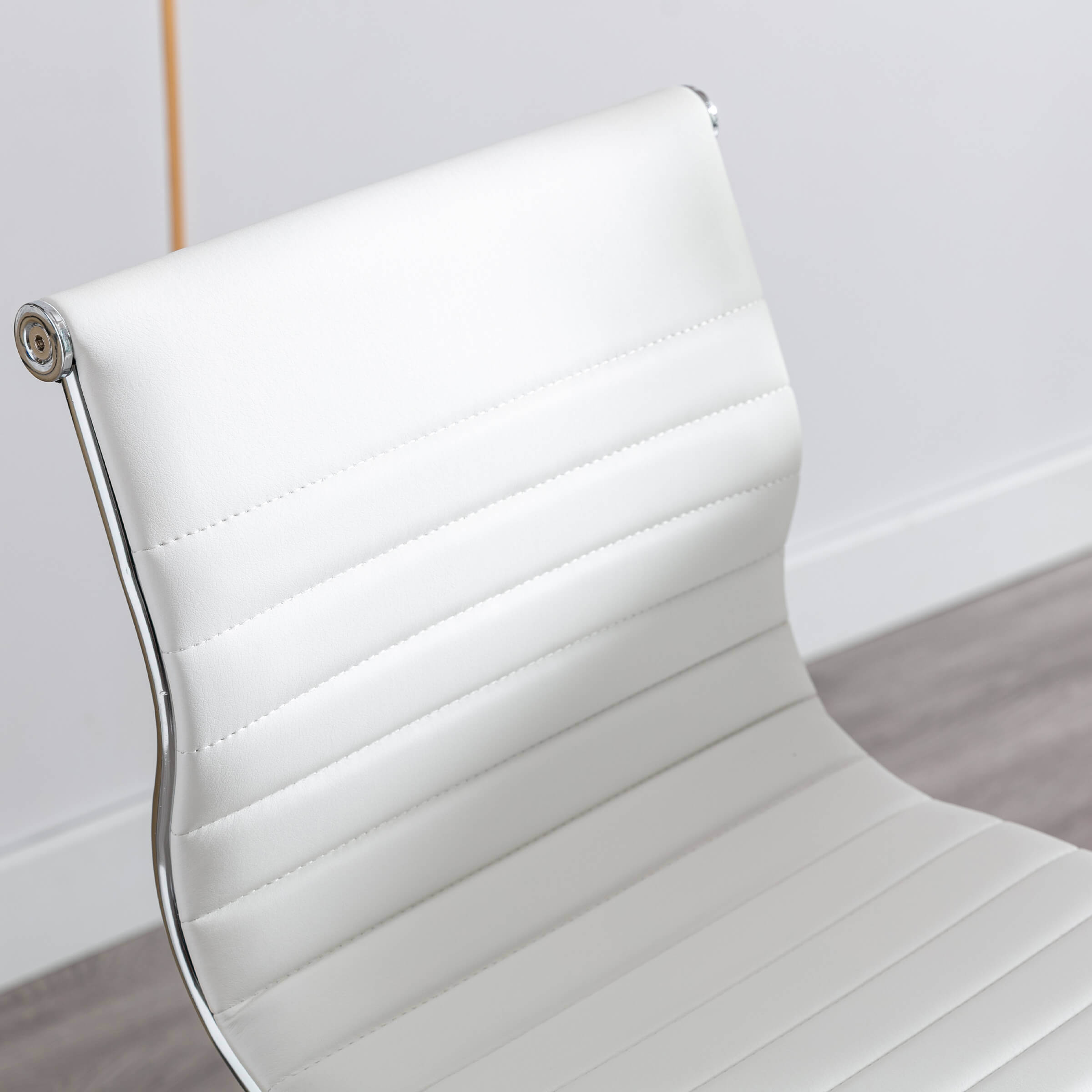 Close-up of white seat surface with stitching