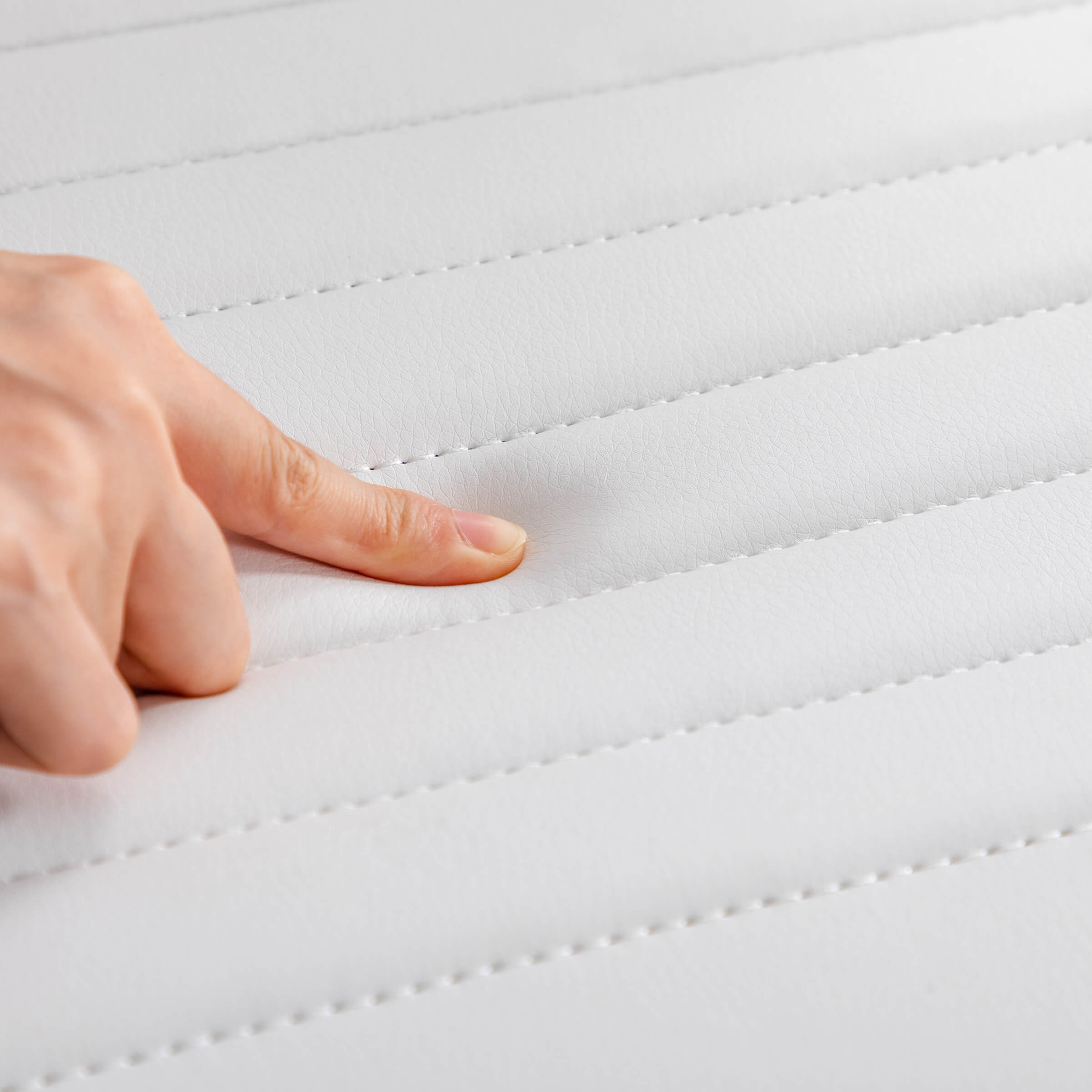 Close-up of white seat padding and stitching