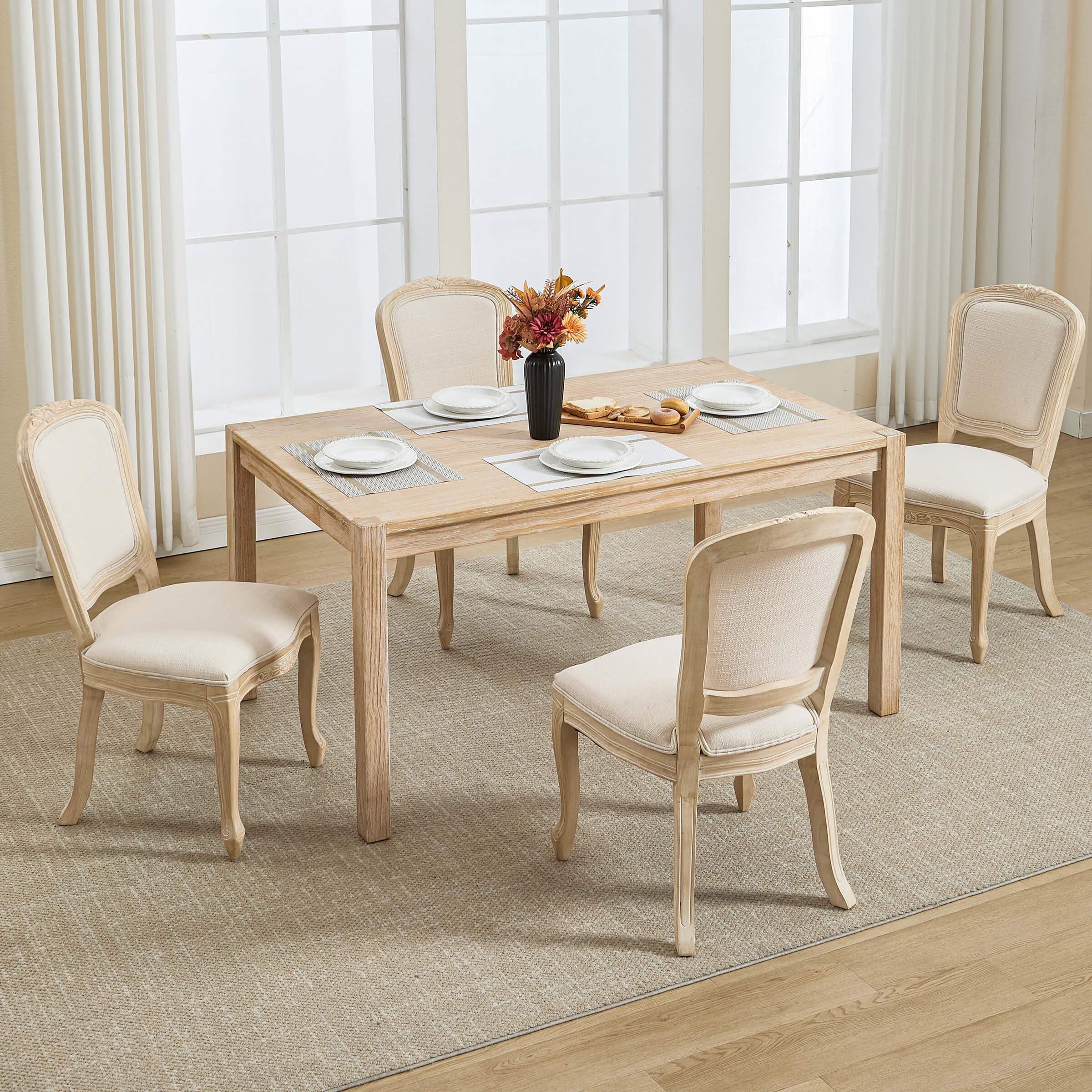 Dining chairs around a table with place settings