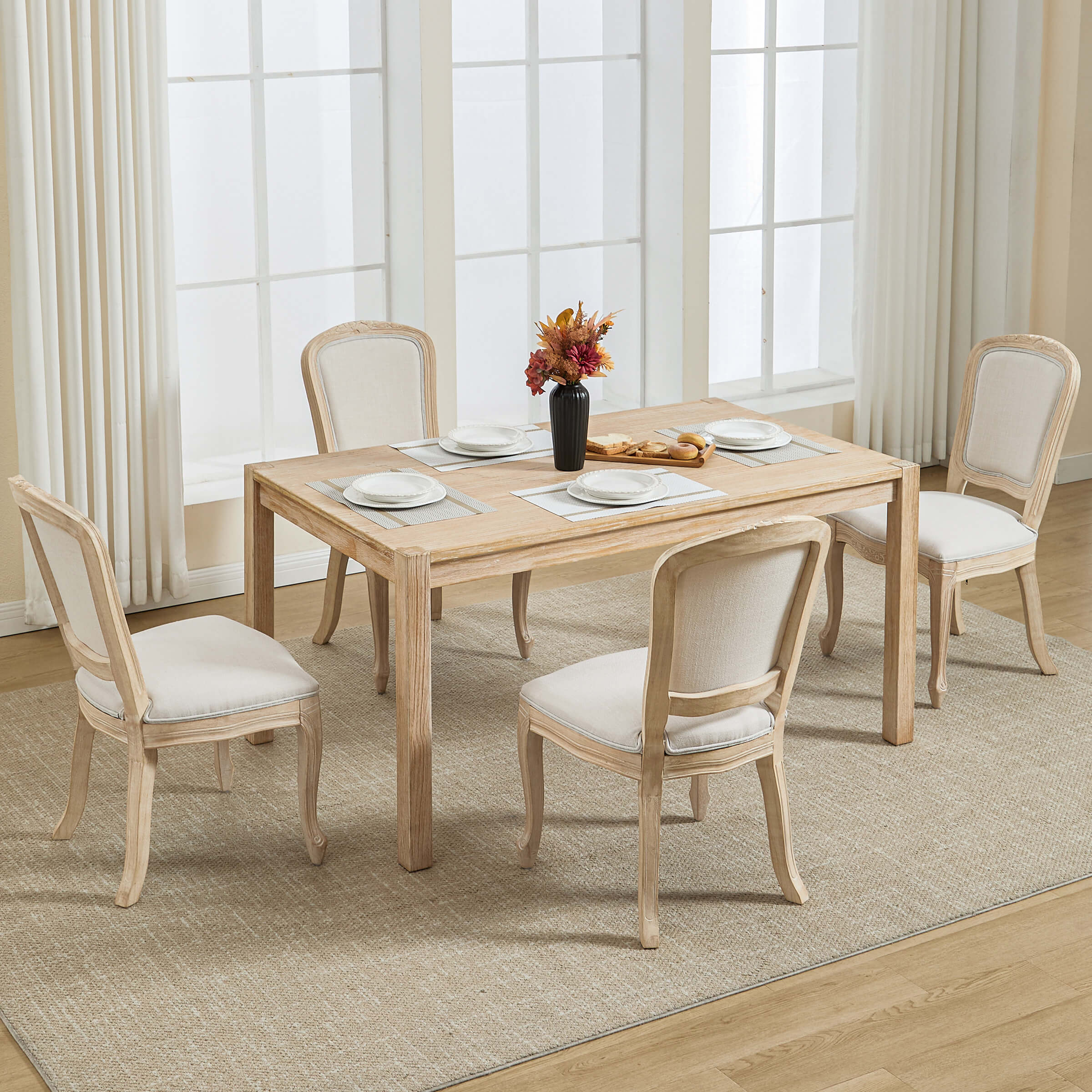 Dining table with four chairs in bright room