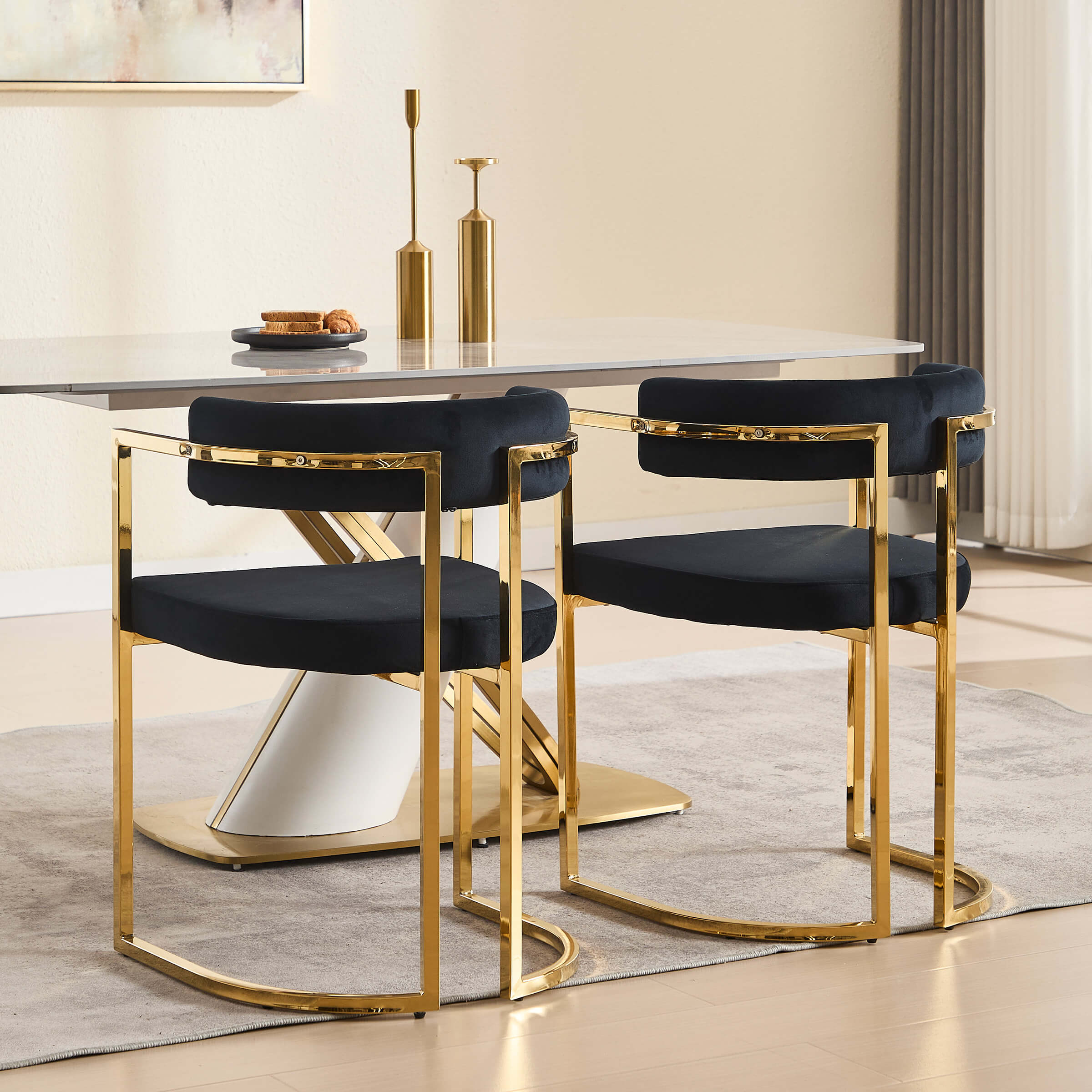 Two navy chairs with gold frames around a table