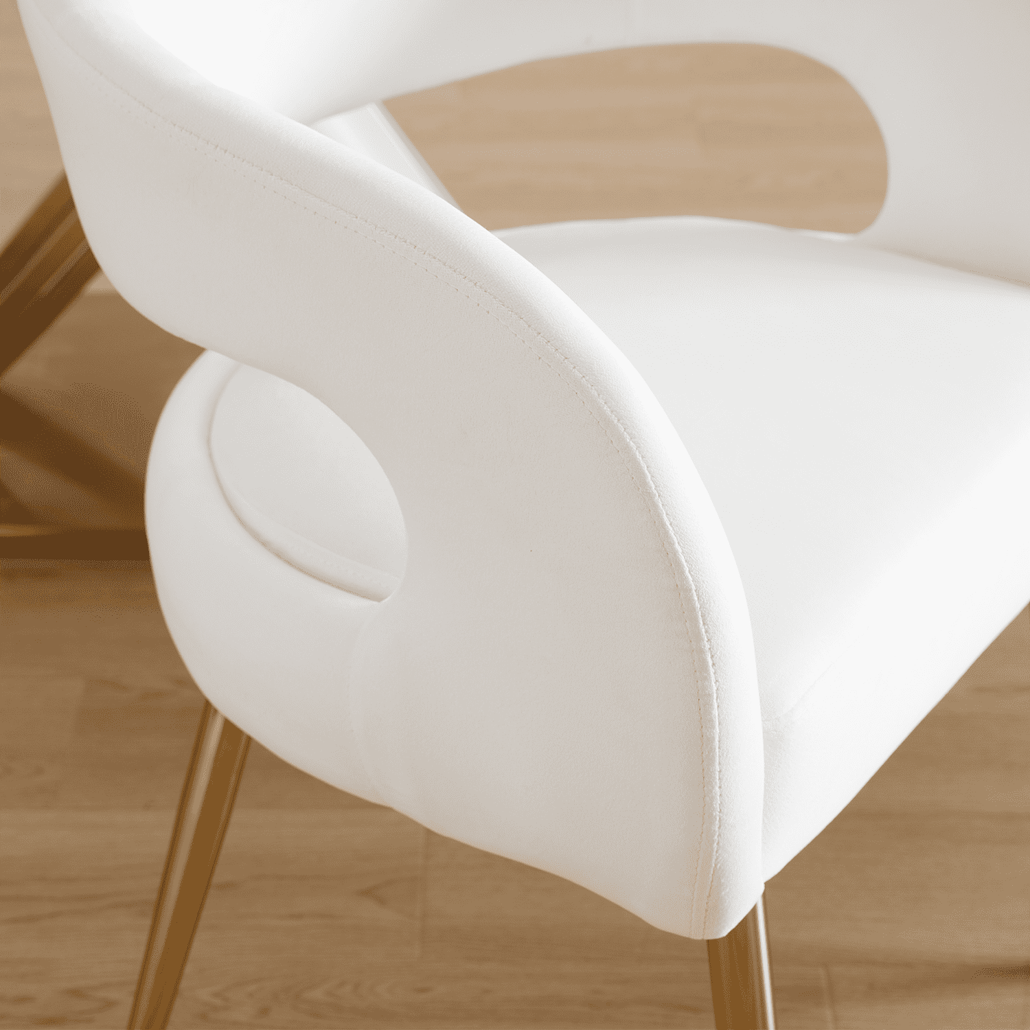 Two white chairs around table in living room